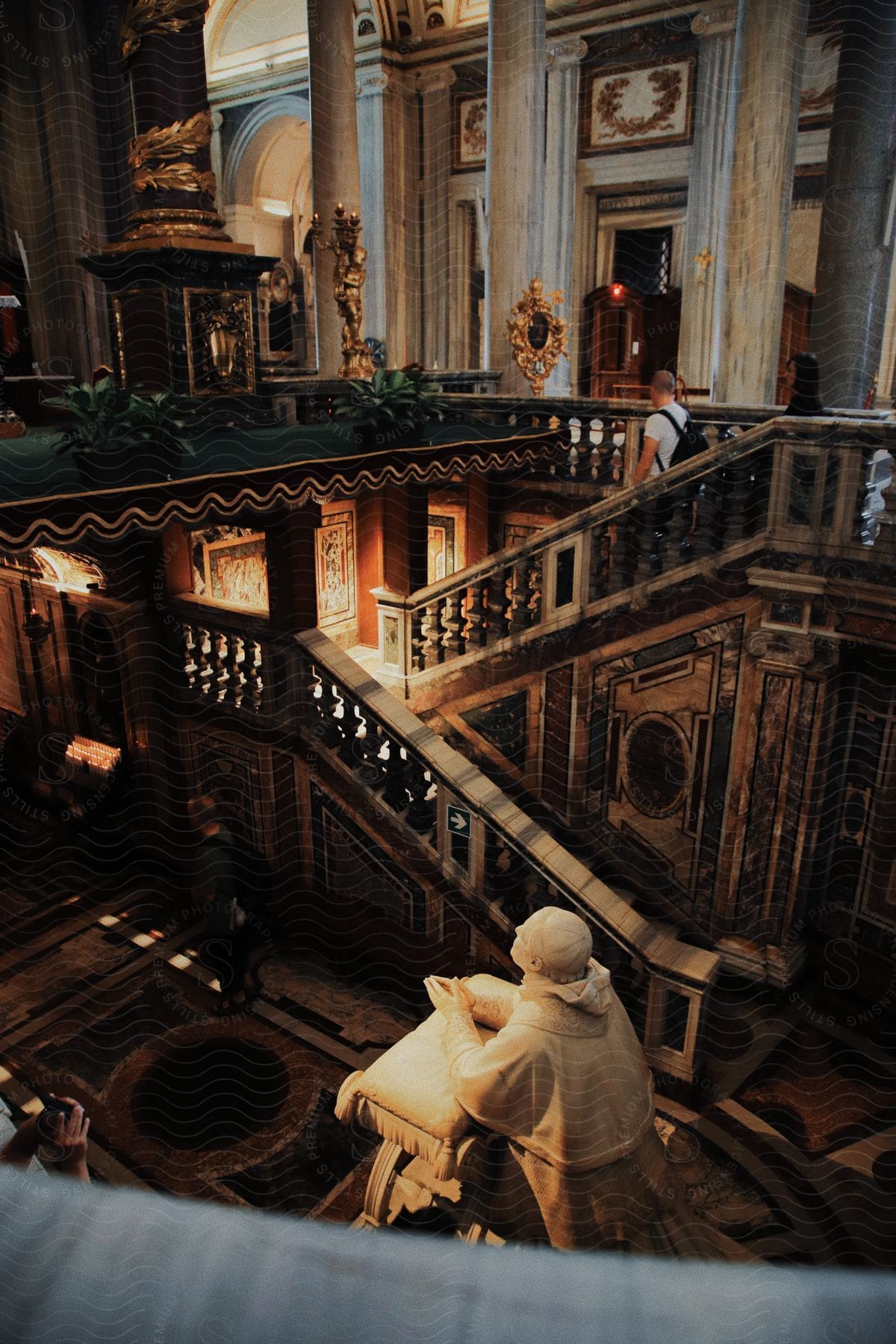 a white man walking down the stairs of Santa Maria Maggiore church which has a statue on the stairway