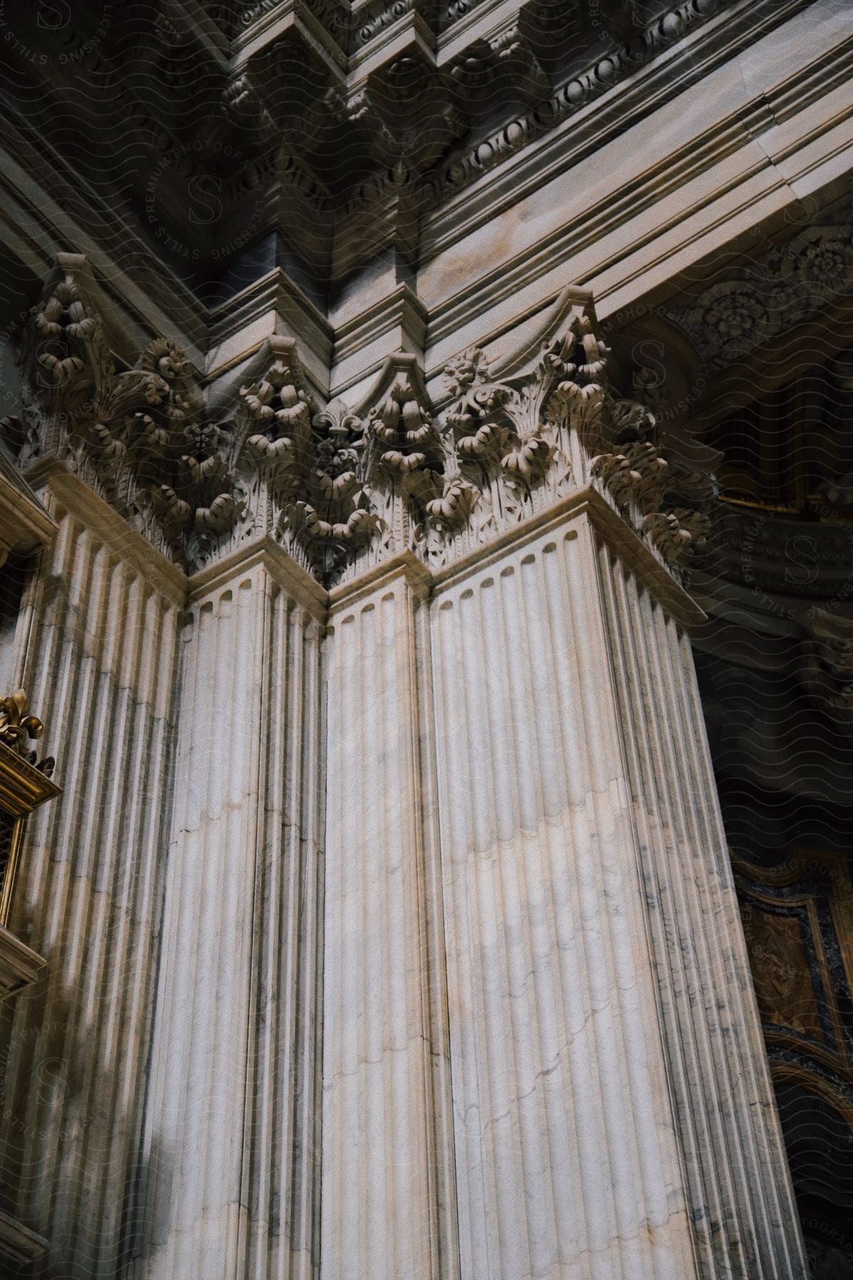 sculptures are carved along the top of tall columns