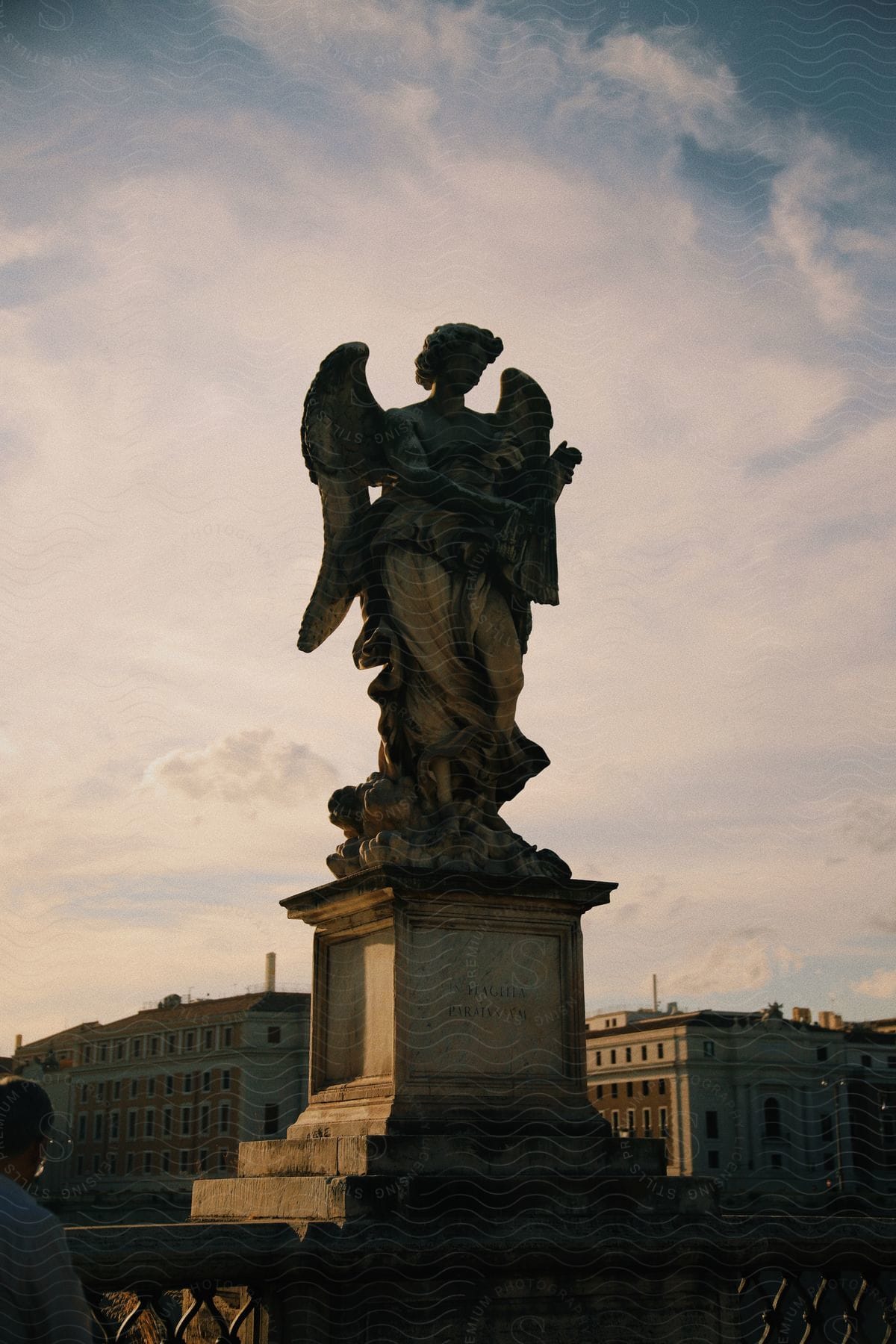 A sculpture of a person with wings in a monument.