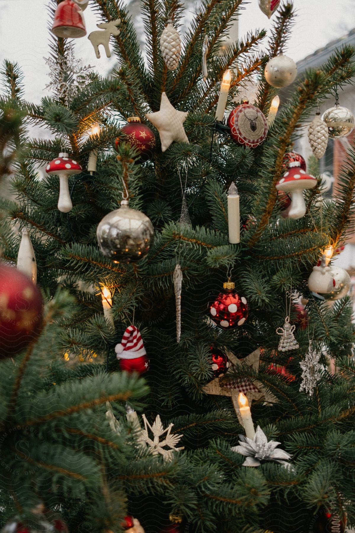 A Christmas tree with many ornaments placed throughout.