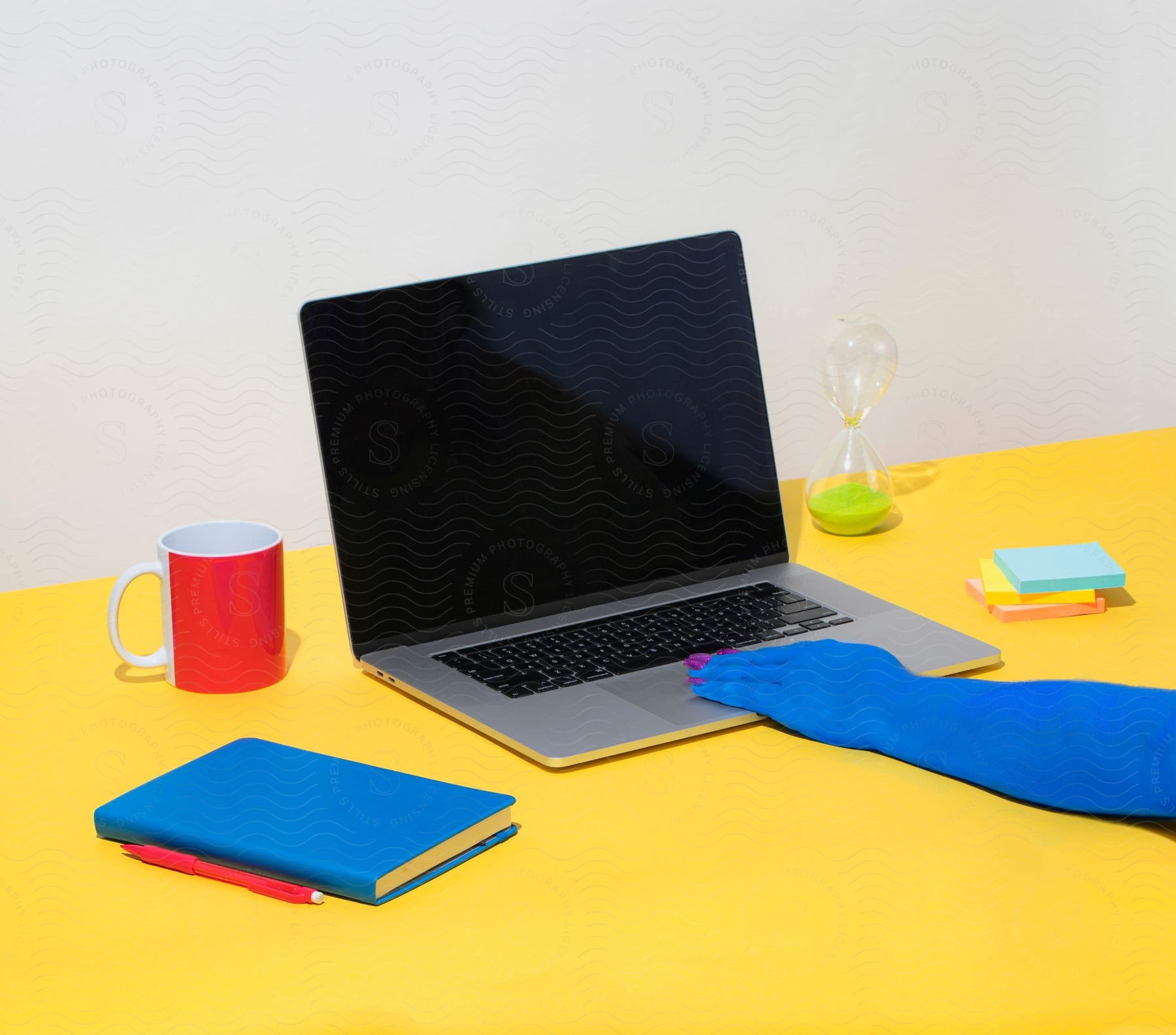 Stock photo of person with blue skin and painted nails touches laptop touchpad.