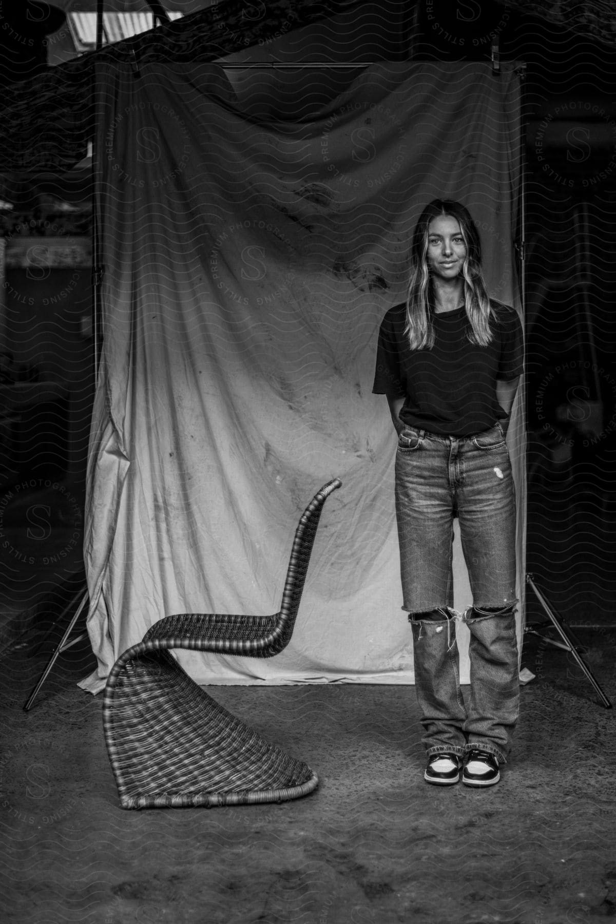 female wearing t-shirt and jeans poses standing