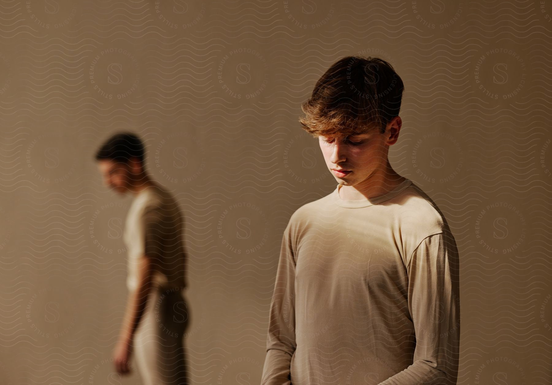 Stock photo of two male models wearing long sleeves, standing at different positions