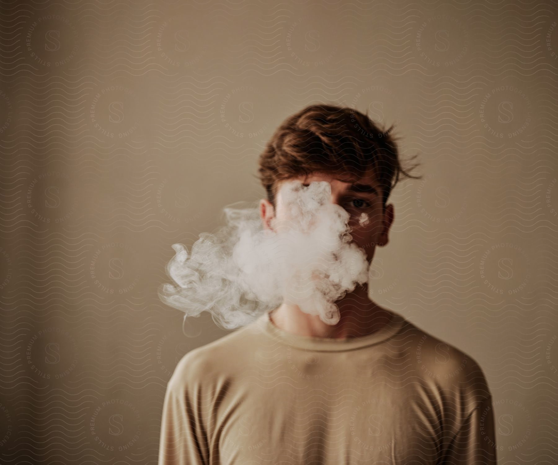 Portrait of a young adult with abstract smoke on his face.