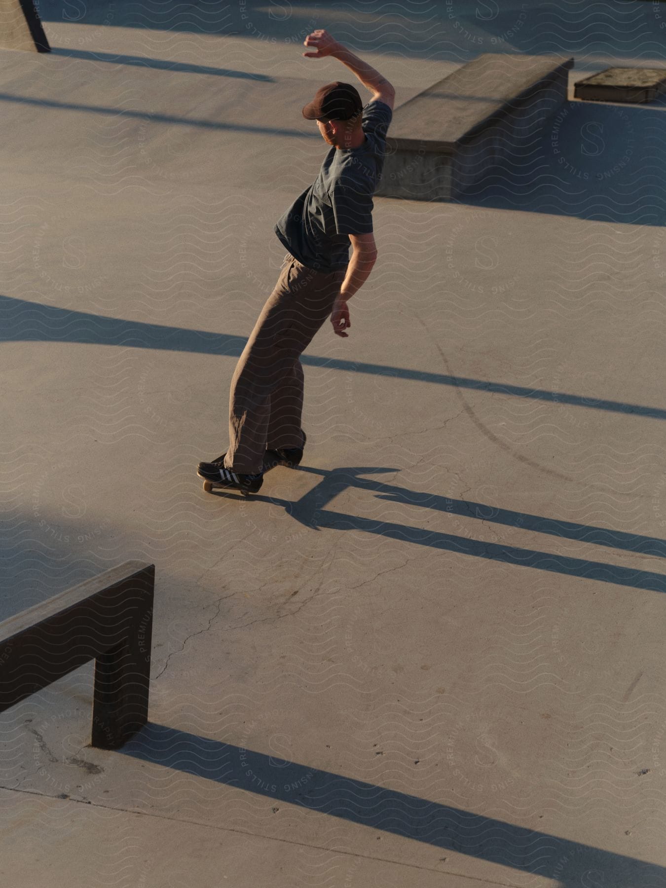 A skateboarder leaning on a concrete rink.