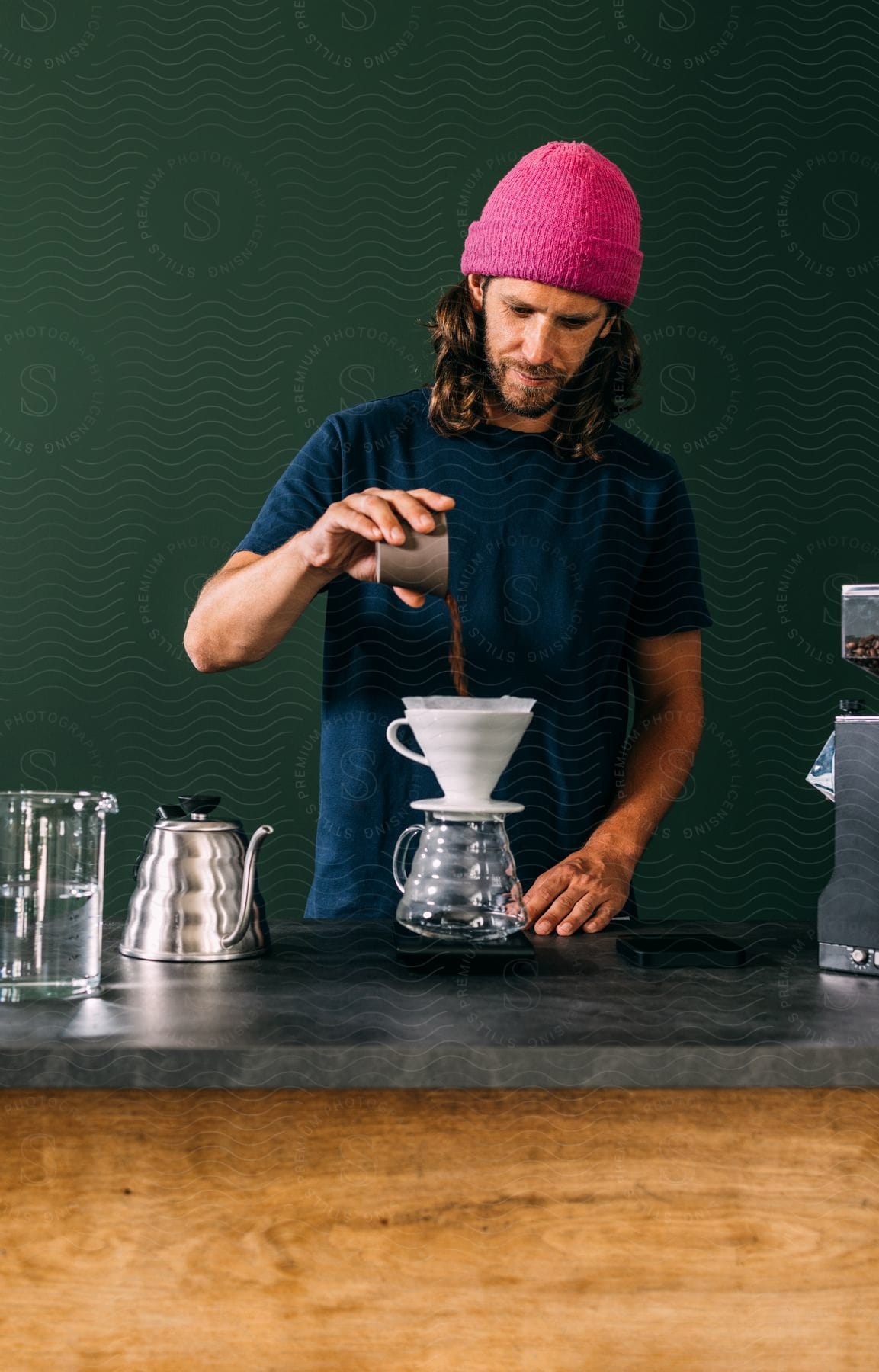 Man pouring coffee grounds into a filter.