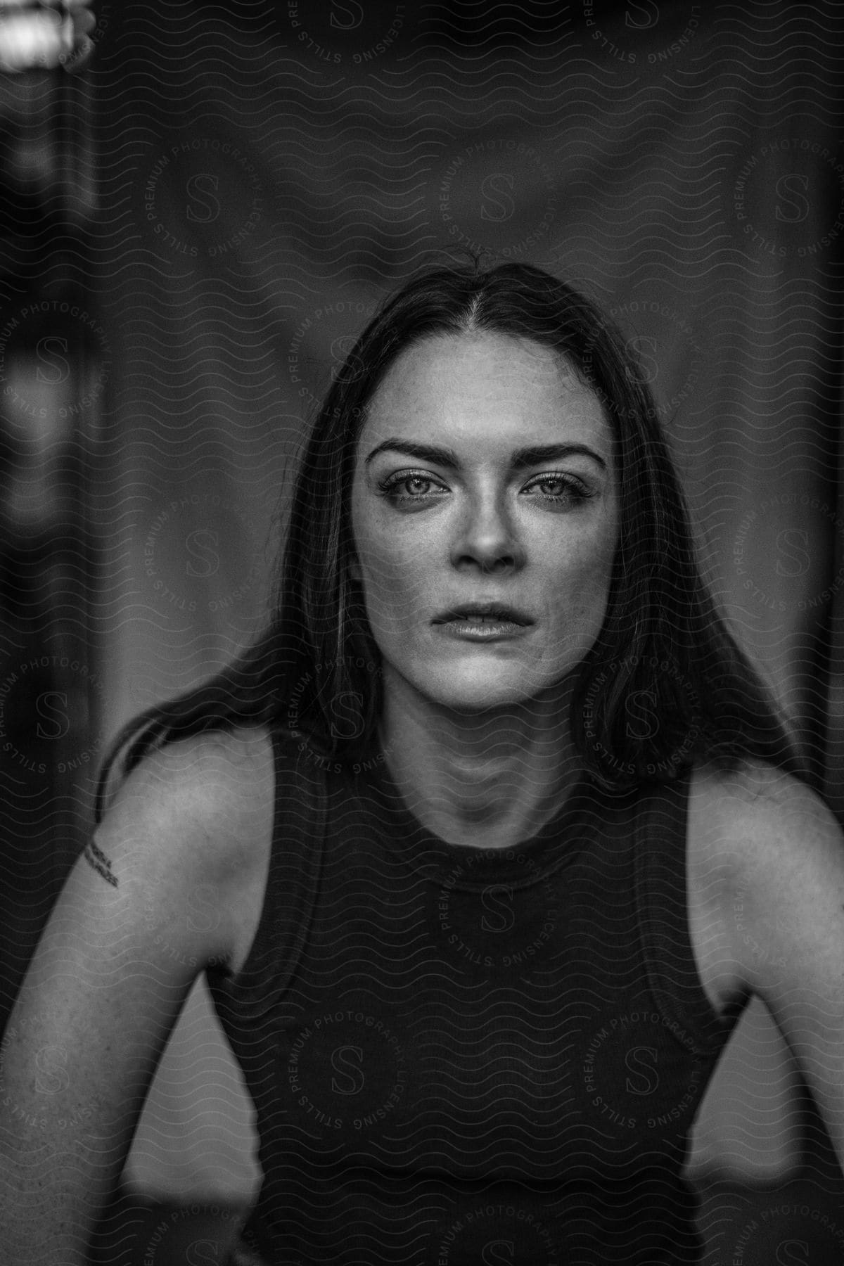 Black and white portrait of a woman with black hair and light eyes.