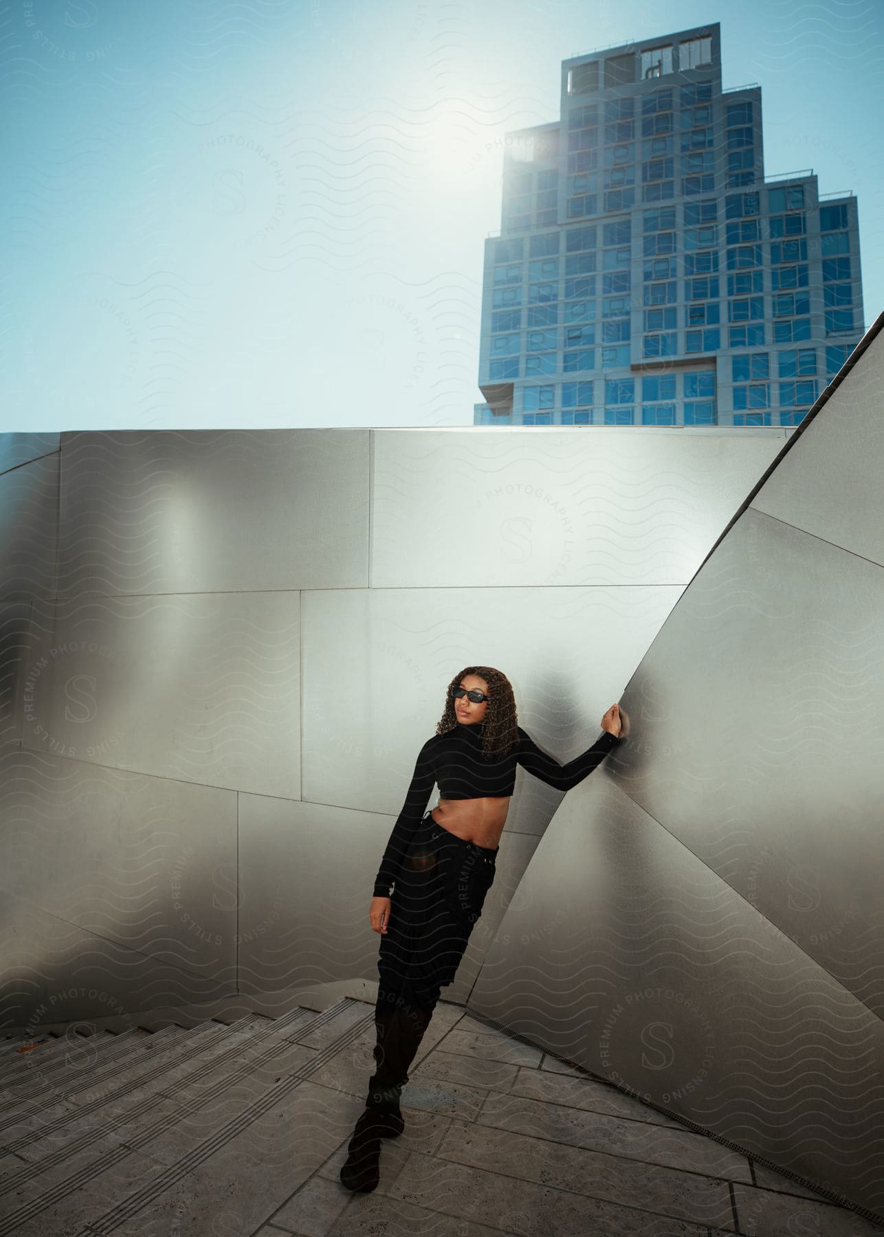 A woman modeling some clothes outdoors on a sunny day