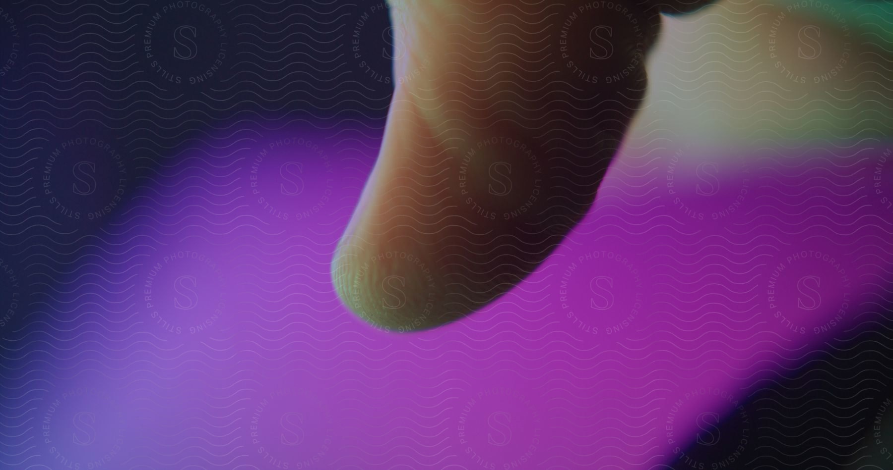 A close-up of a finger touching a phone screen.