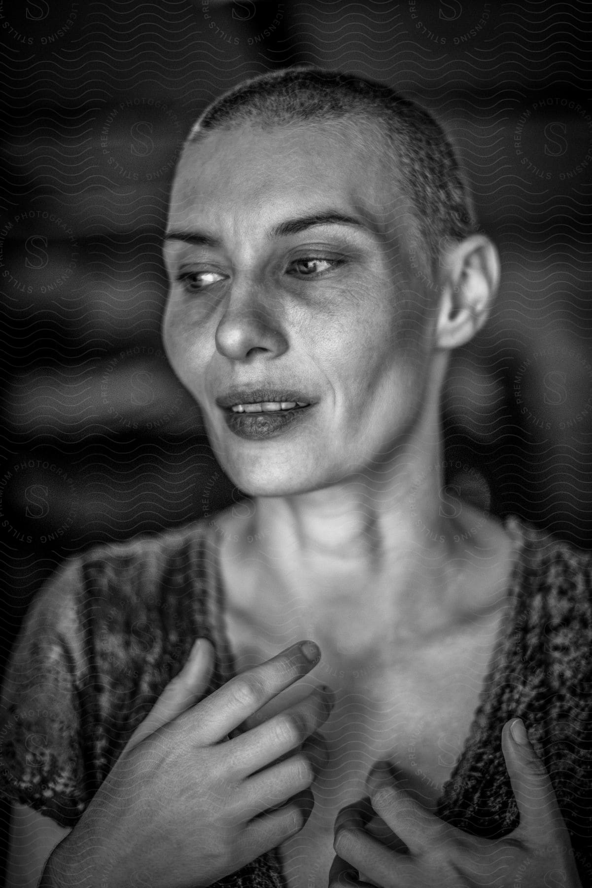 A black and white portrat of a woman standing in a room.