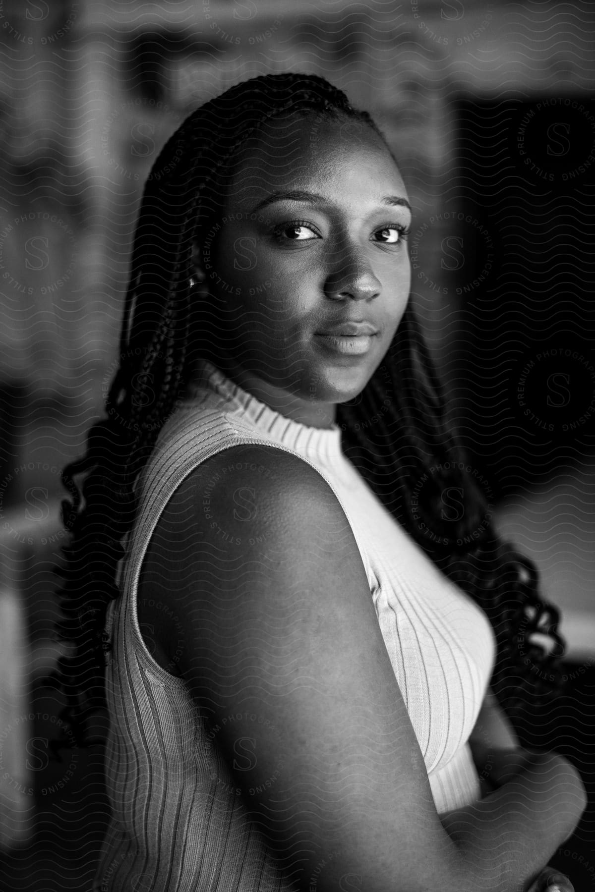 A portrait of a woman standing and looking directly at the camera.