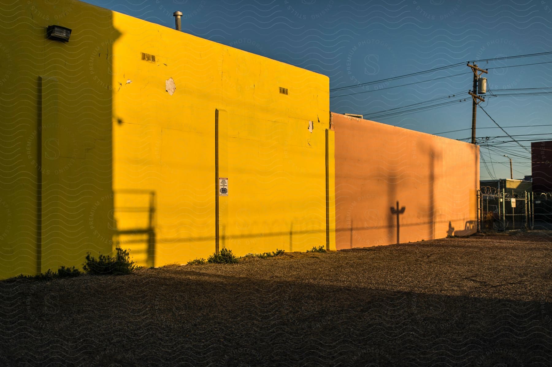 Yellow and orange wall with sunlight on them.