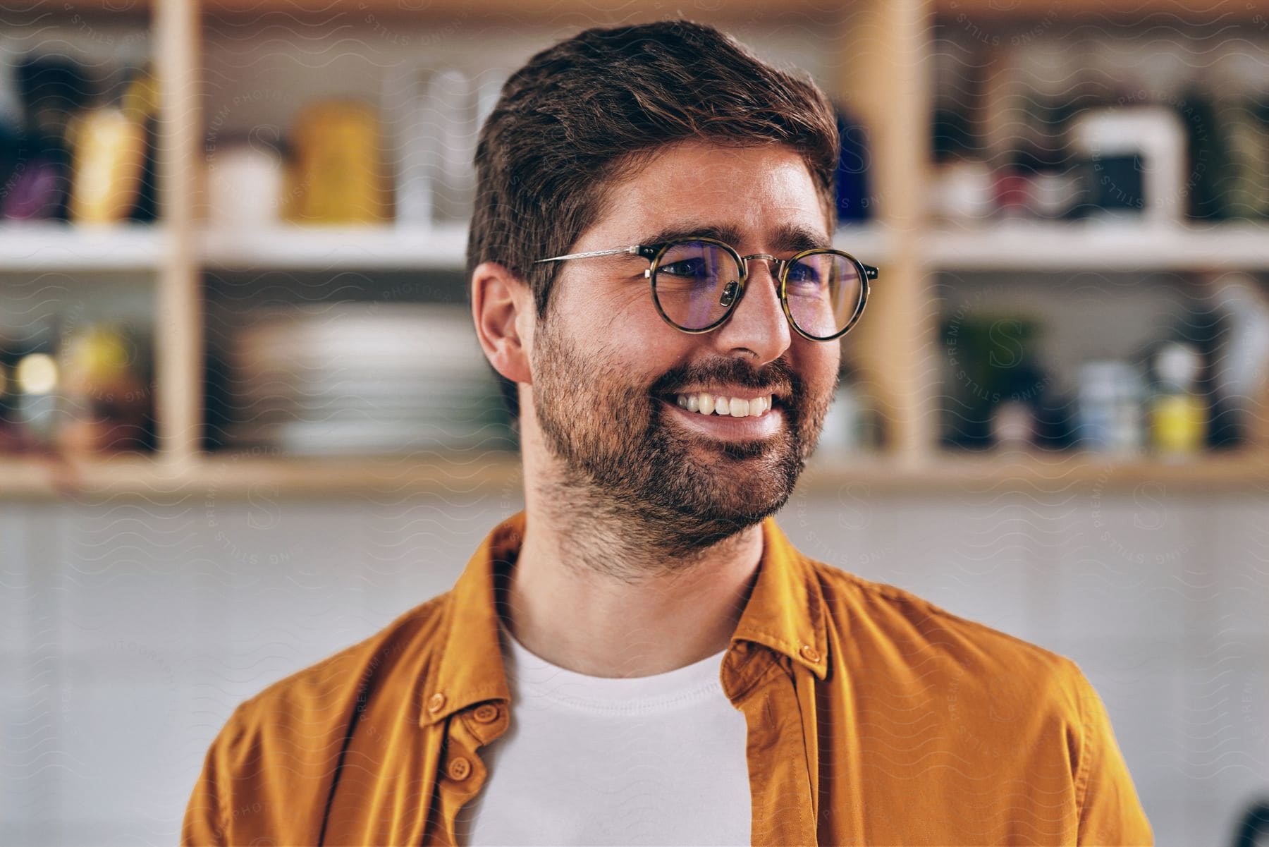 A man smiles as he turns his head to the side