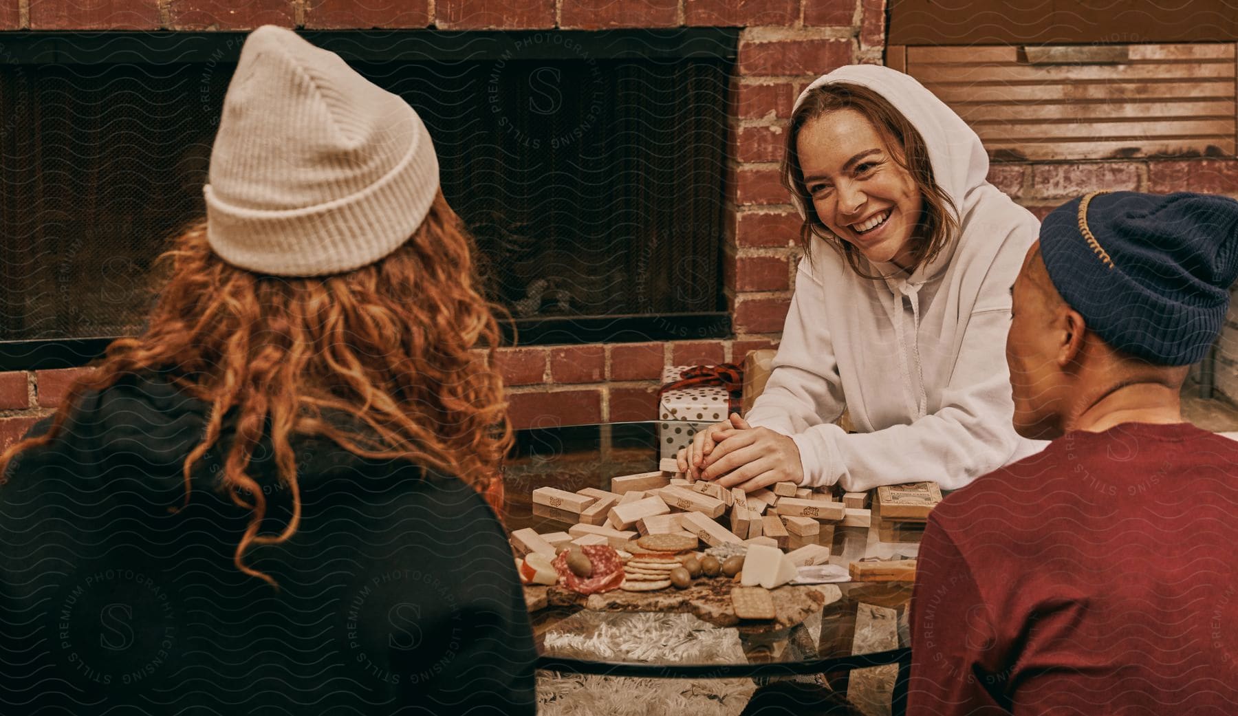 Women playing Jenga are excited and laughing