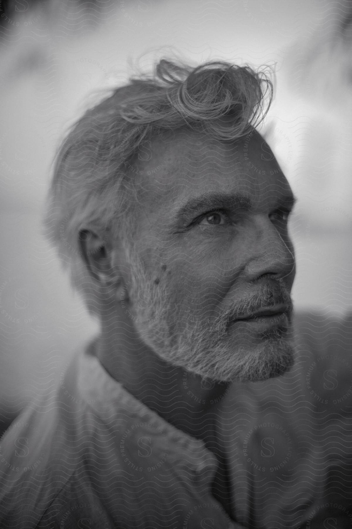 Face of an older man with short white hair