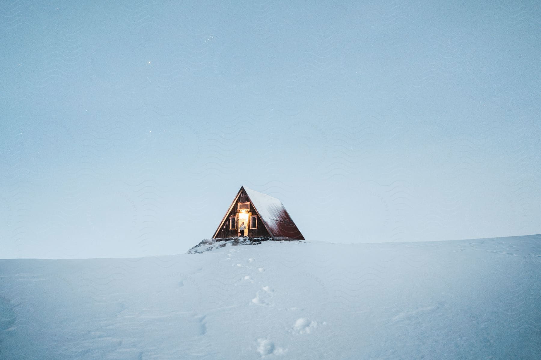 a cabin in the middle of nowhere all covered in snow