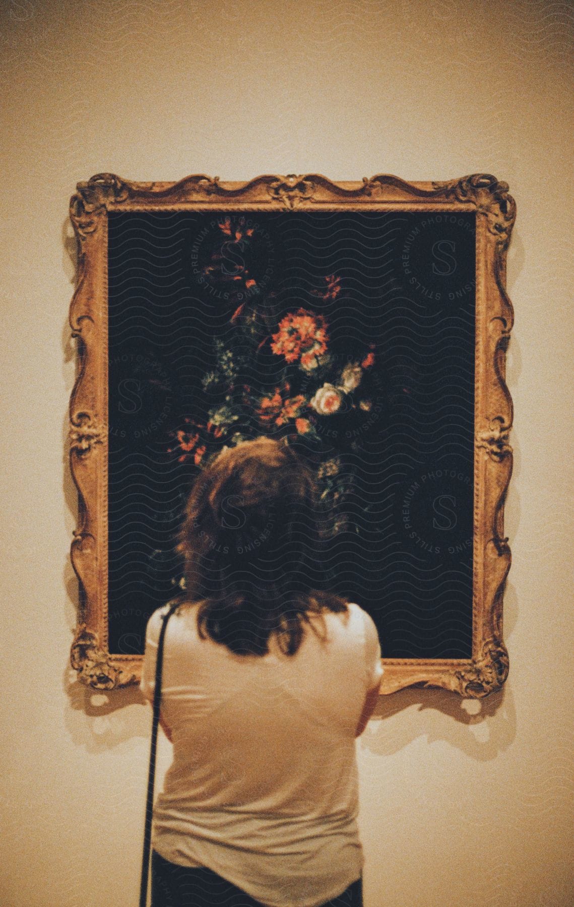 Woman facing both forward and backward in front of an artwork.