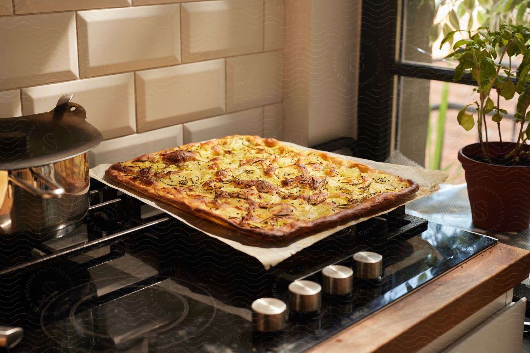 A rectangular flat bread pizza on parchment paper fresh out of the oven