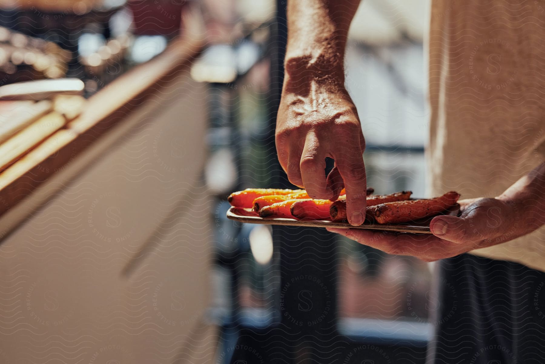 Man serving cooked carrots