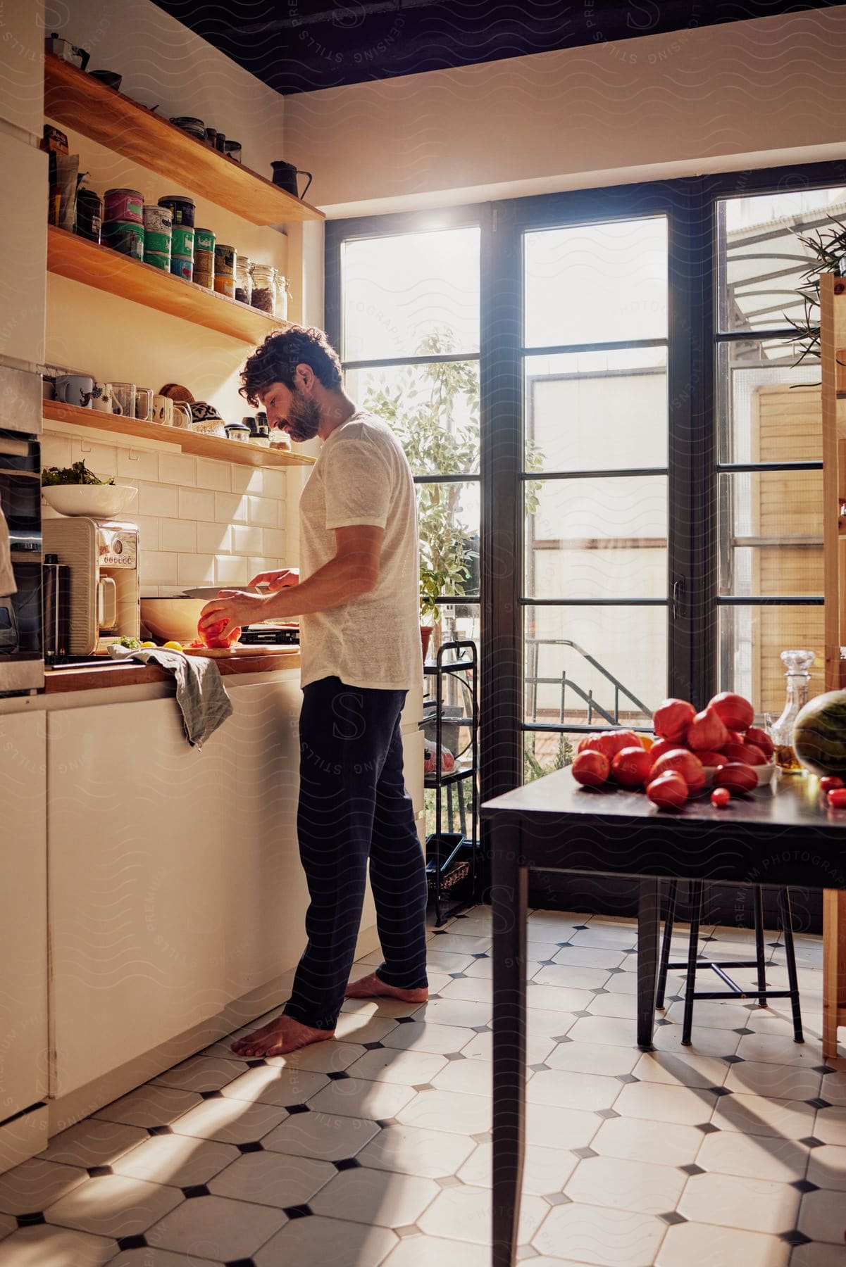 Young man cooking in the kitchen at home on a sunny day