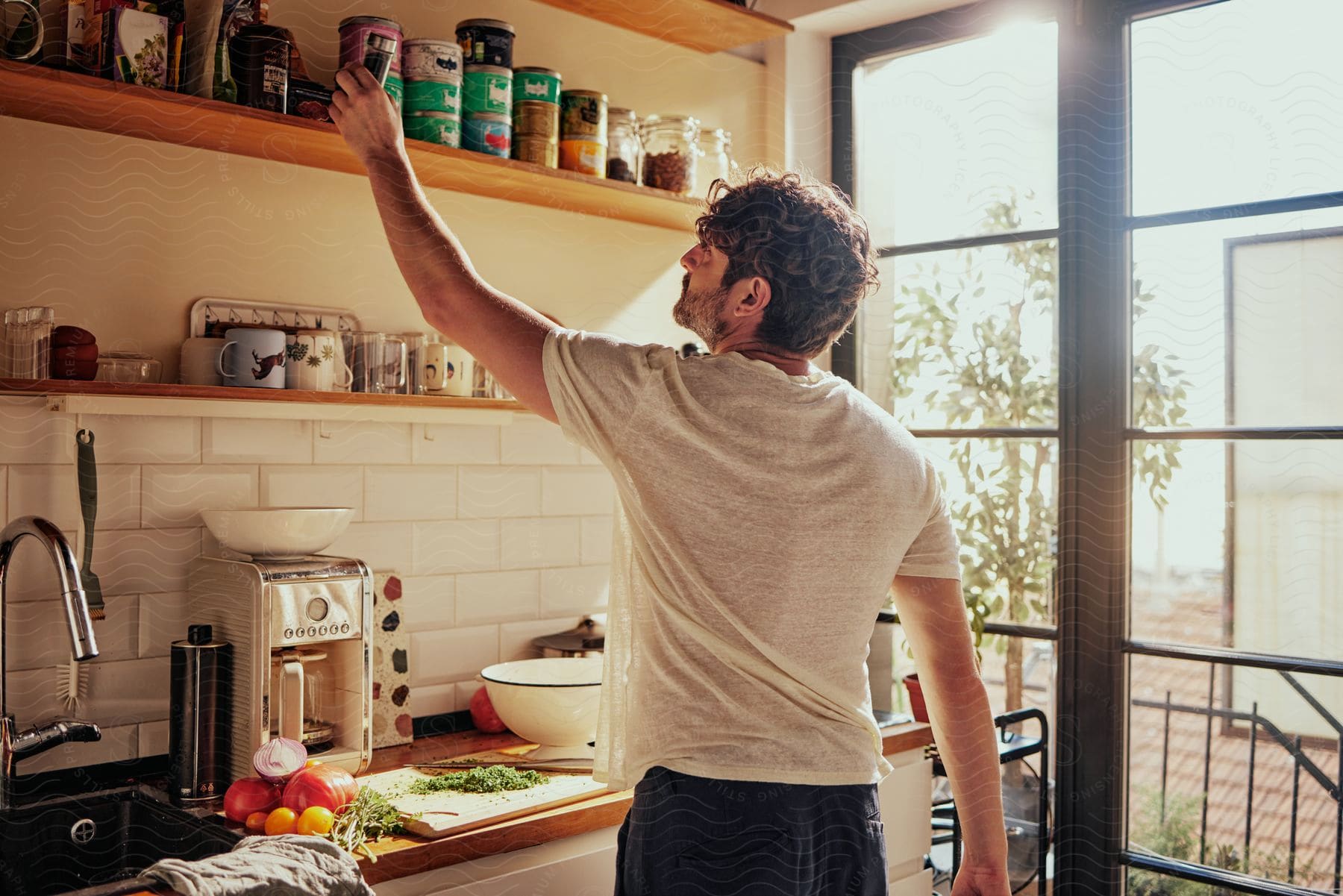 Young man cooking in the kitchen at home on a sunny day