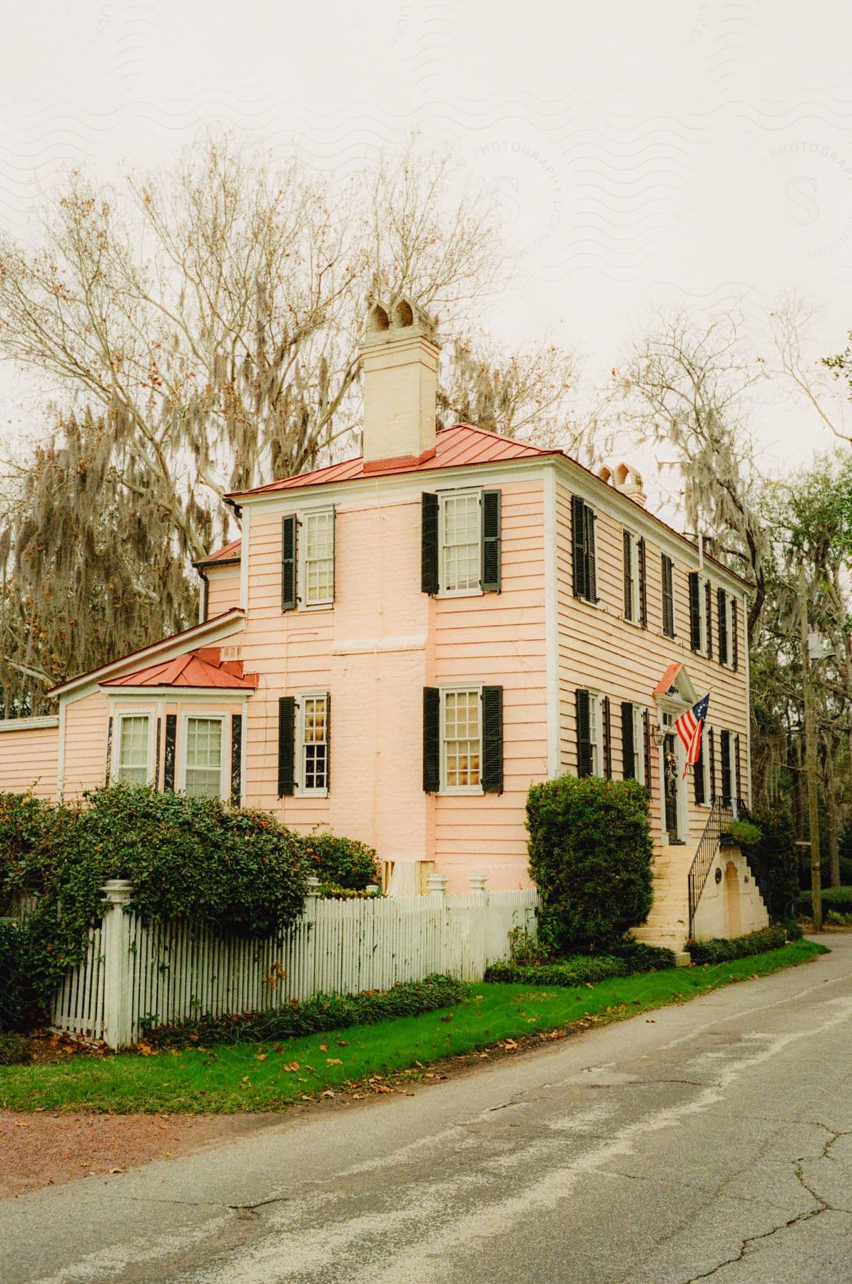 A house sitting in a neighborhood on a cloudy day.