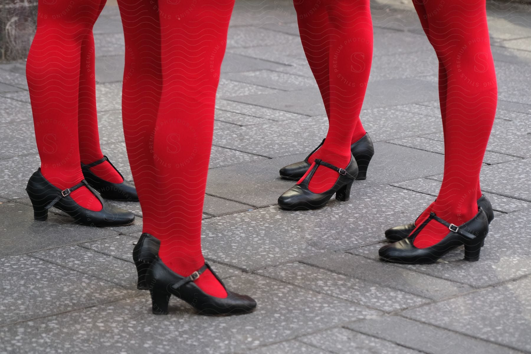 a group of women wearing red tights and black shoes