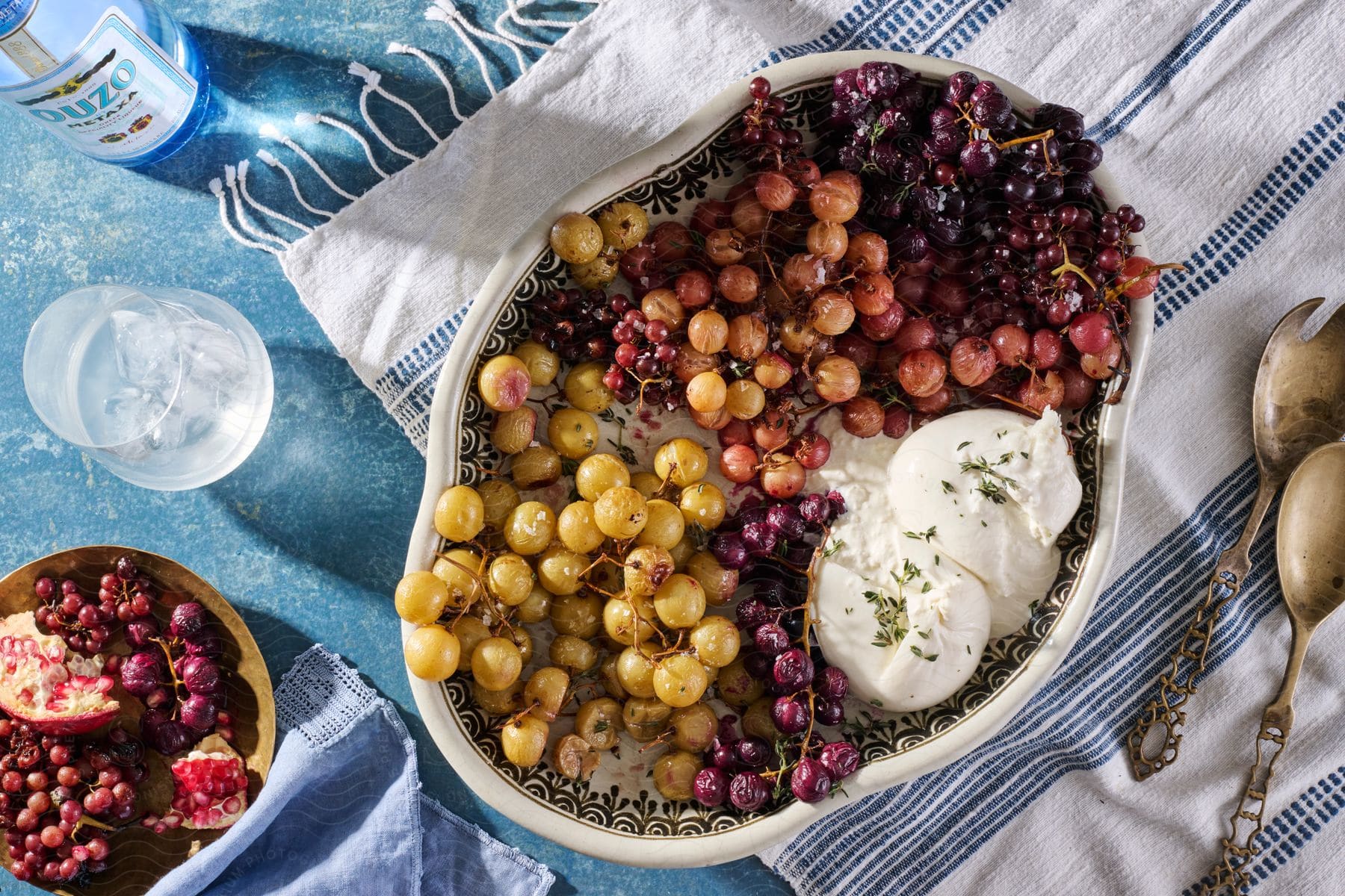 A bowl of fruit on a tablecloth covered table.