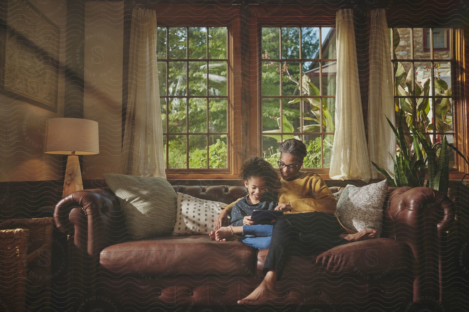 Interior design of a room with a leather sofa and two people sitting.