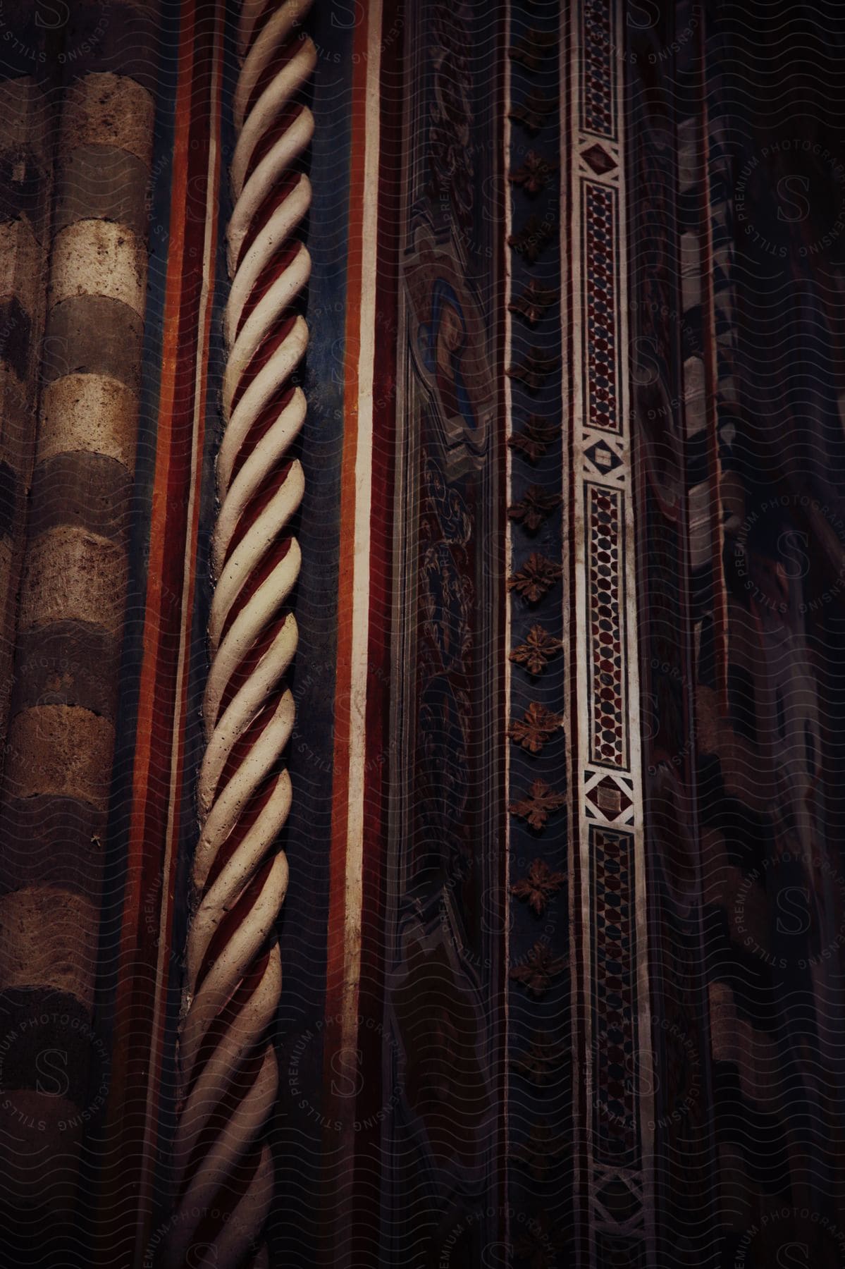 Ornate architectural details with striped columns and patterns with a moody lighting.