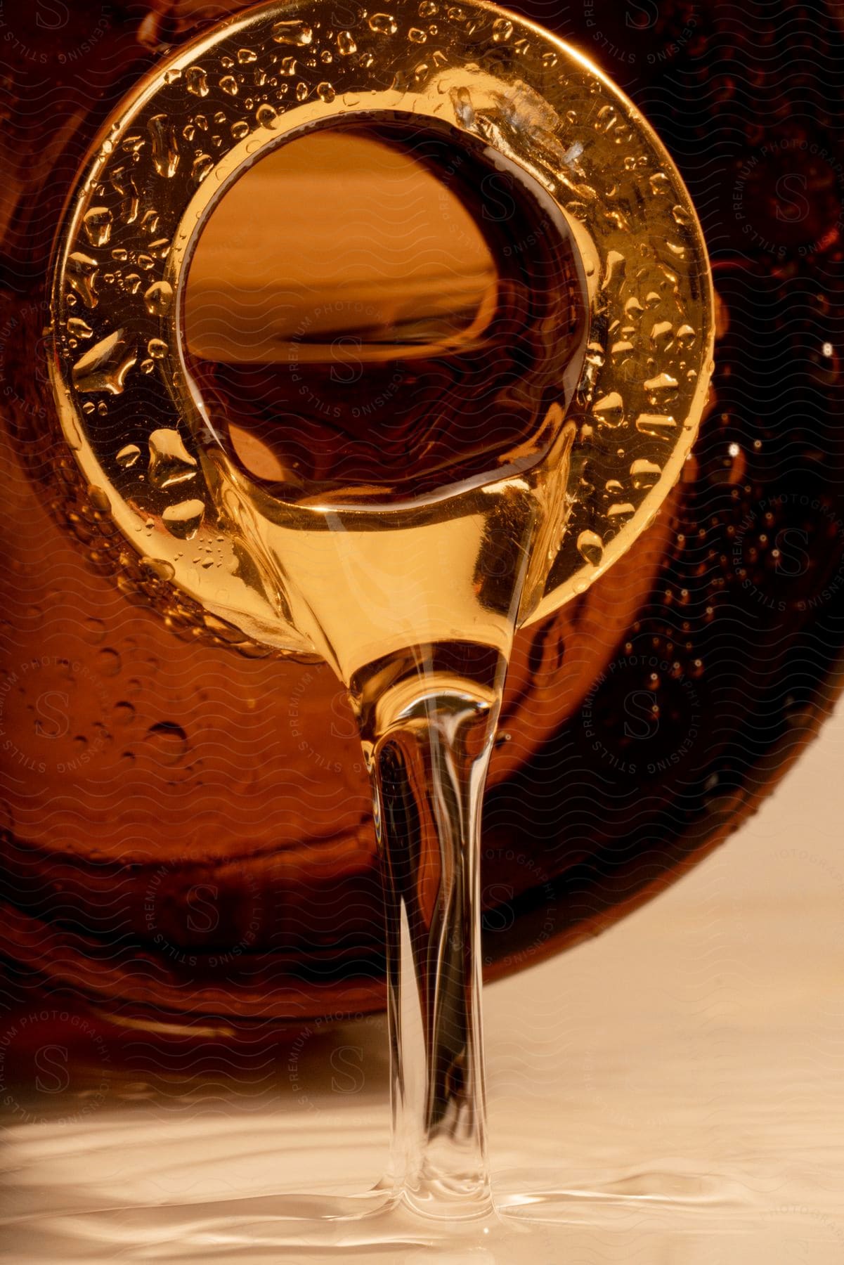 Some oil being poured from a jar onto a plate.