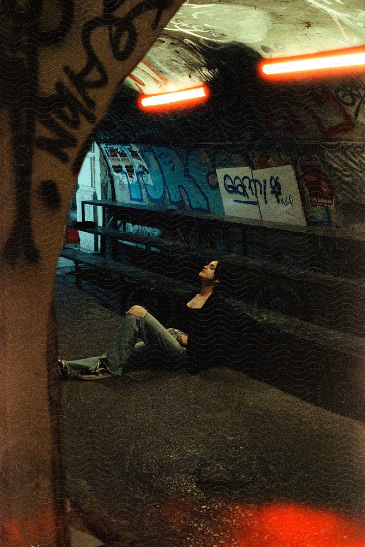 Woman sitting in an indoor metro space.