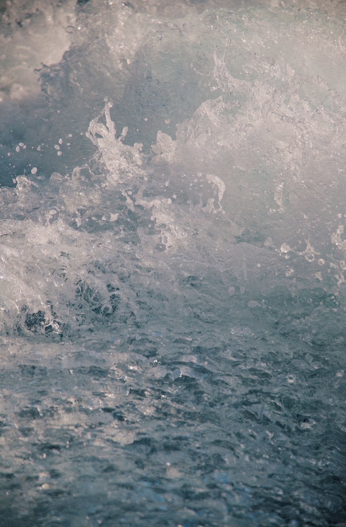 Flowing water churns into whitewater before calming.