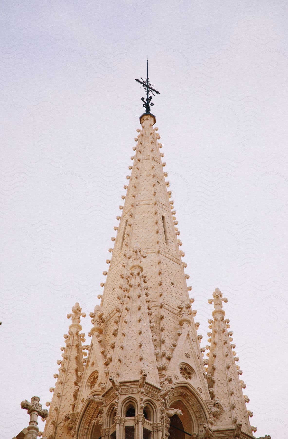 Architecture of the Matthias Church tower under a cloudy sky.