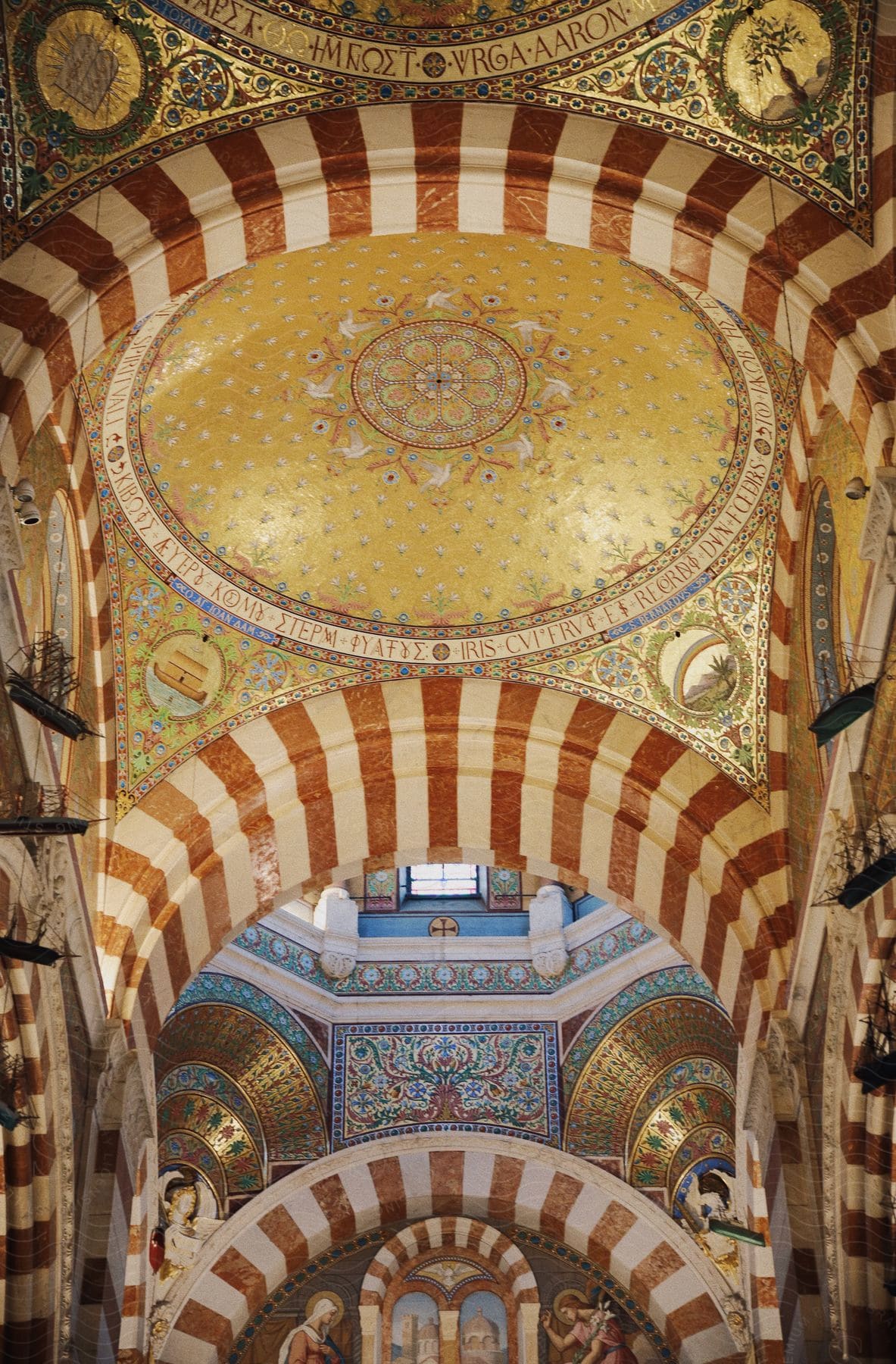 An interior look of a building in which the ceilings and walls are shaped circularly with art painted throughout.