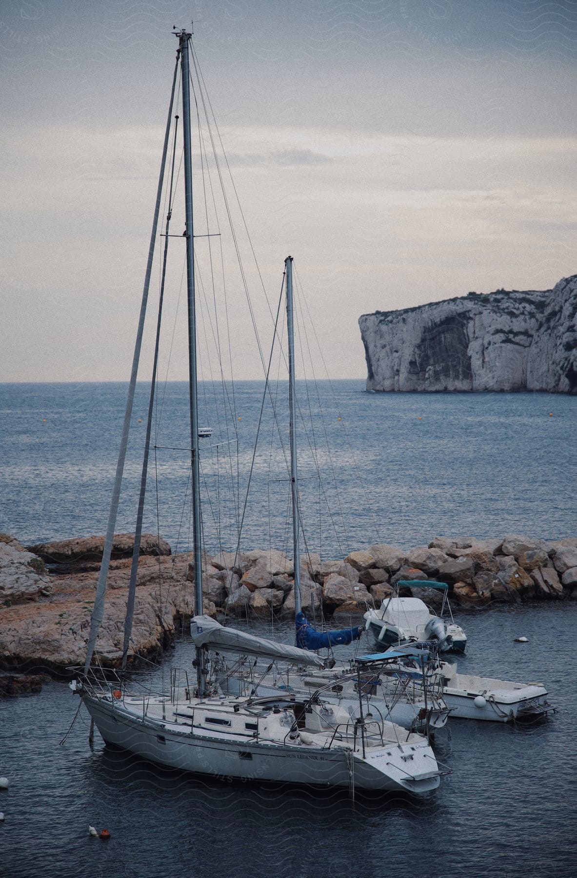 Two yachts parked side by side in the sea.