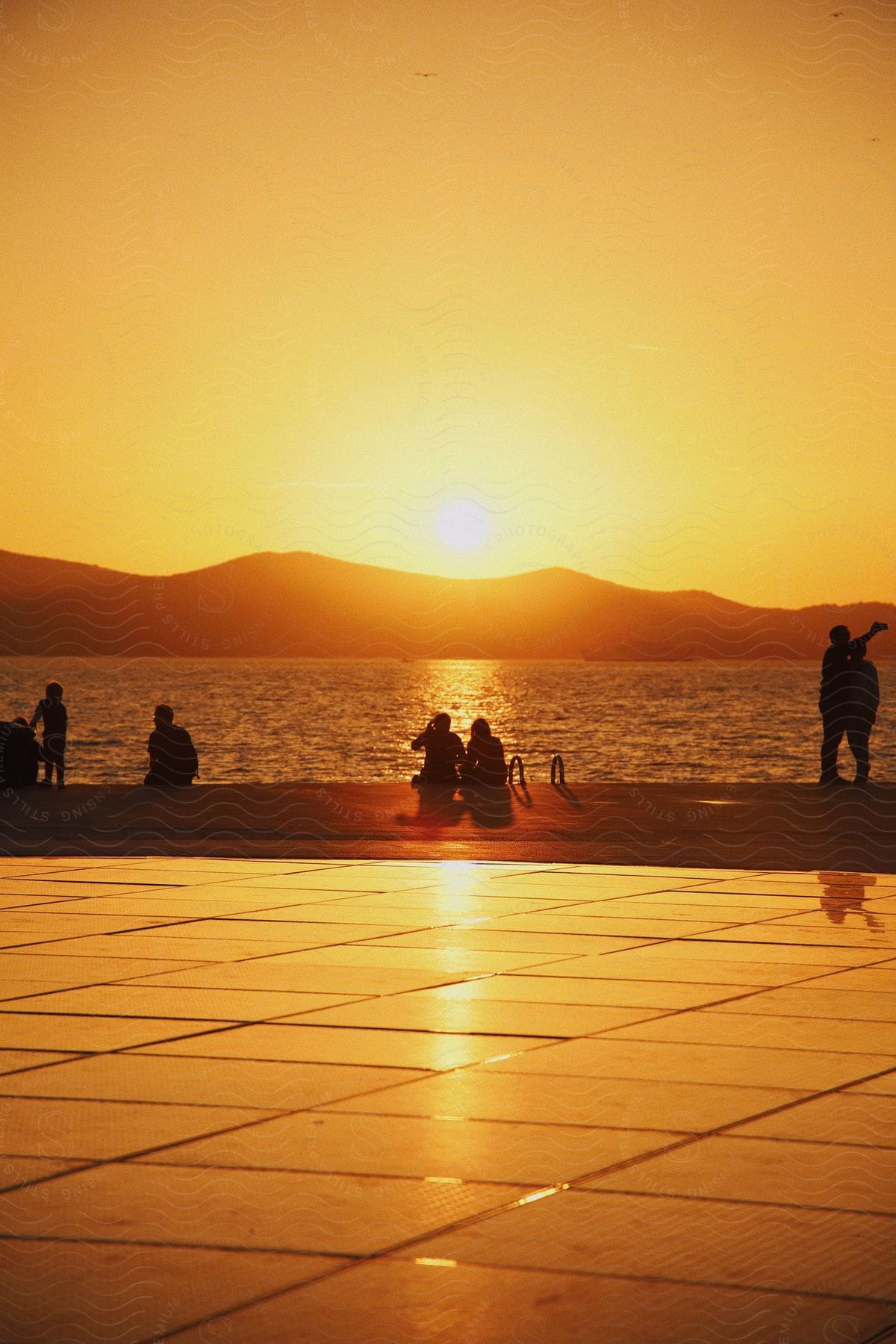 Silhouette of people in the coast at sunset