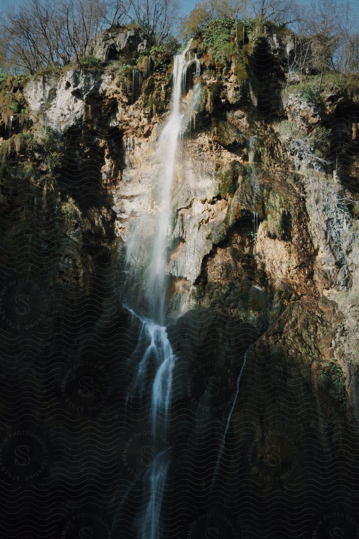 a waterfall cascading down a rocky cliff.