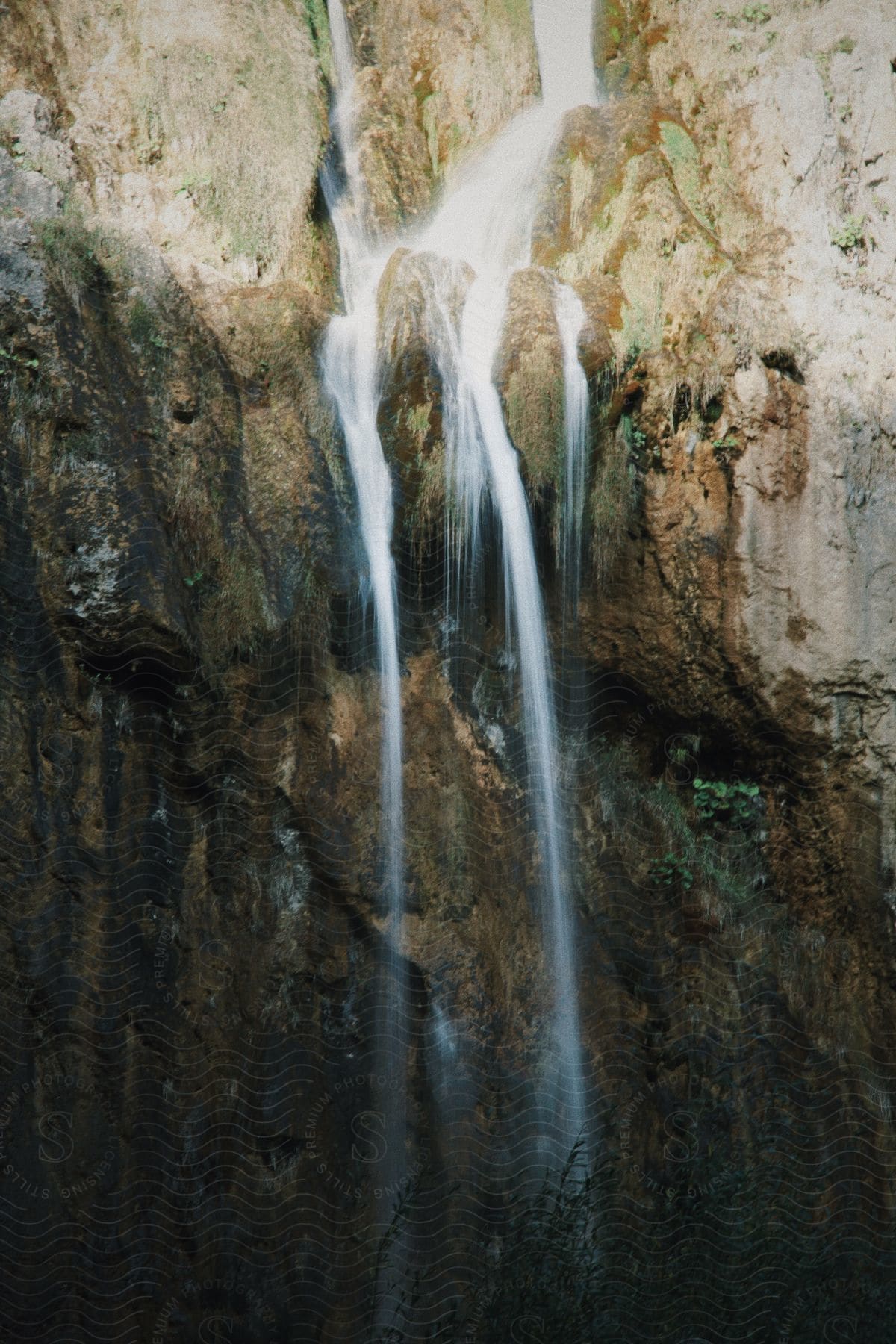 close up of water flowing down on rocks at mid-day