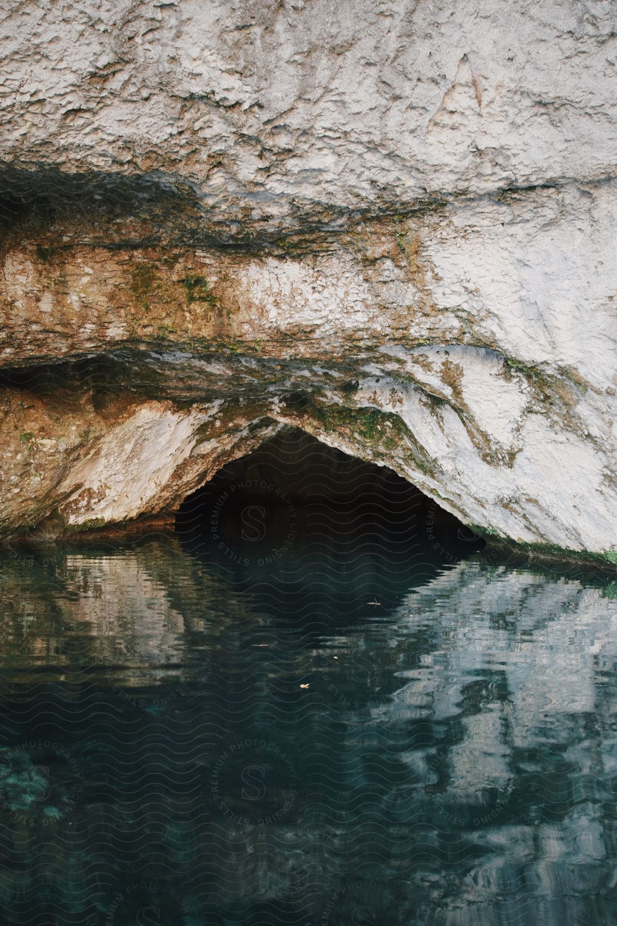 A view of a cave on the edge of the ocean.