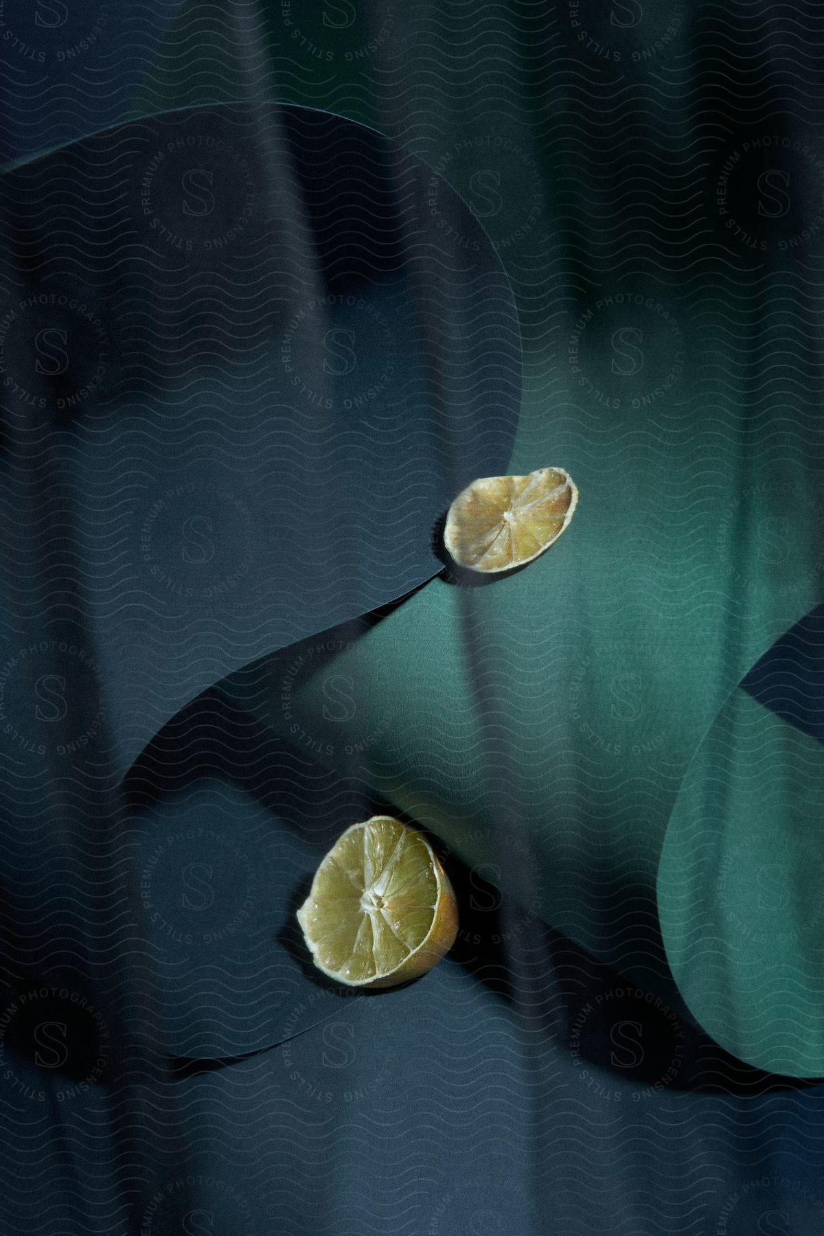 Stock photo of lemon slices on green paper background