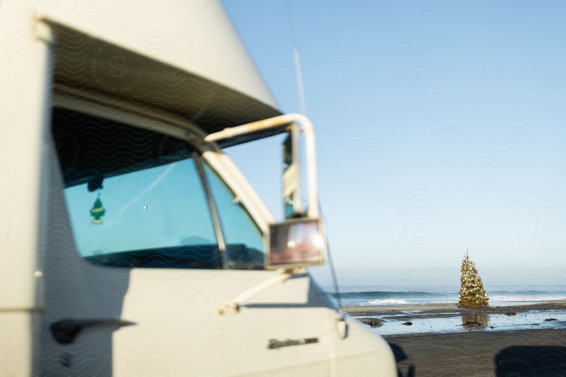 a van parked by the beach on a sunny day