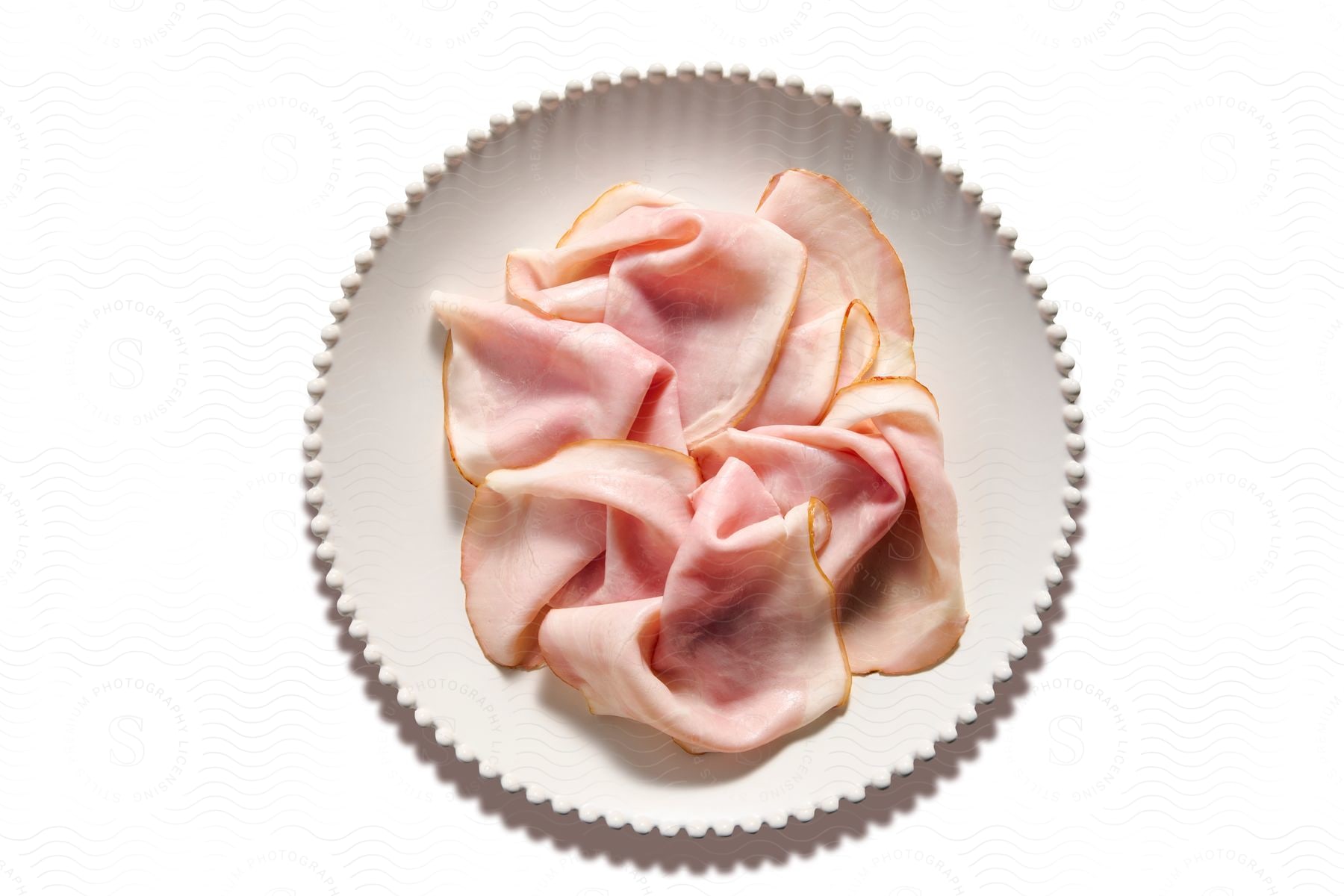 A piece of pink fabric in a white plate