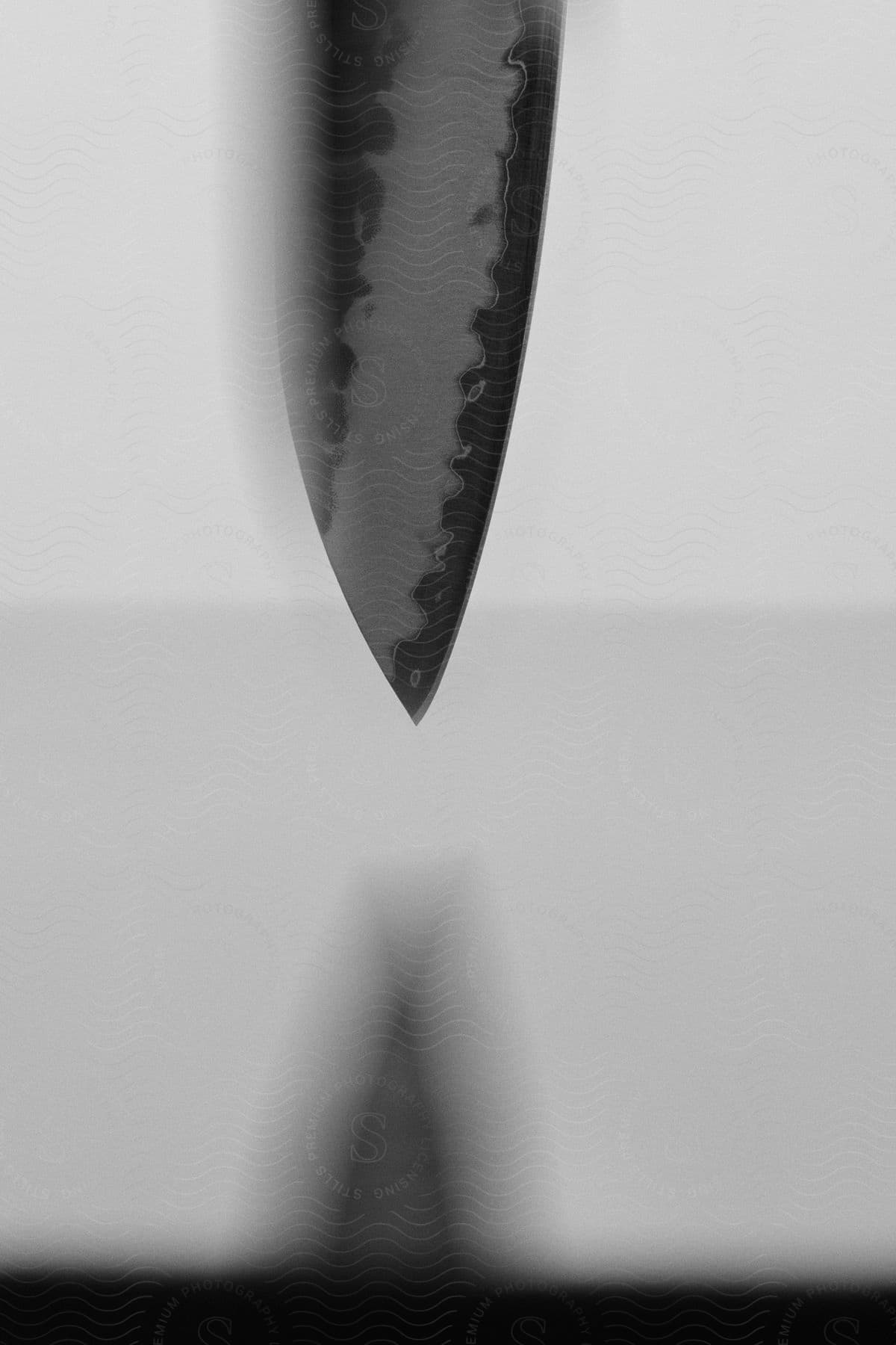 Tip of an abstract knife in black and white.