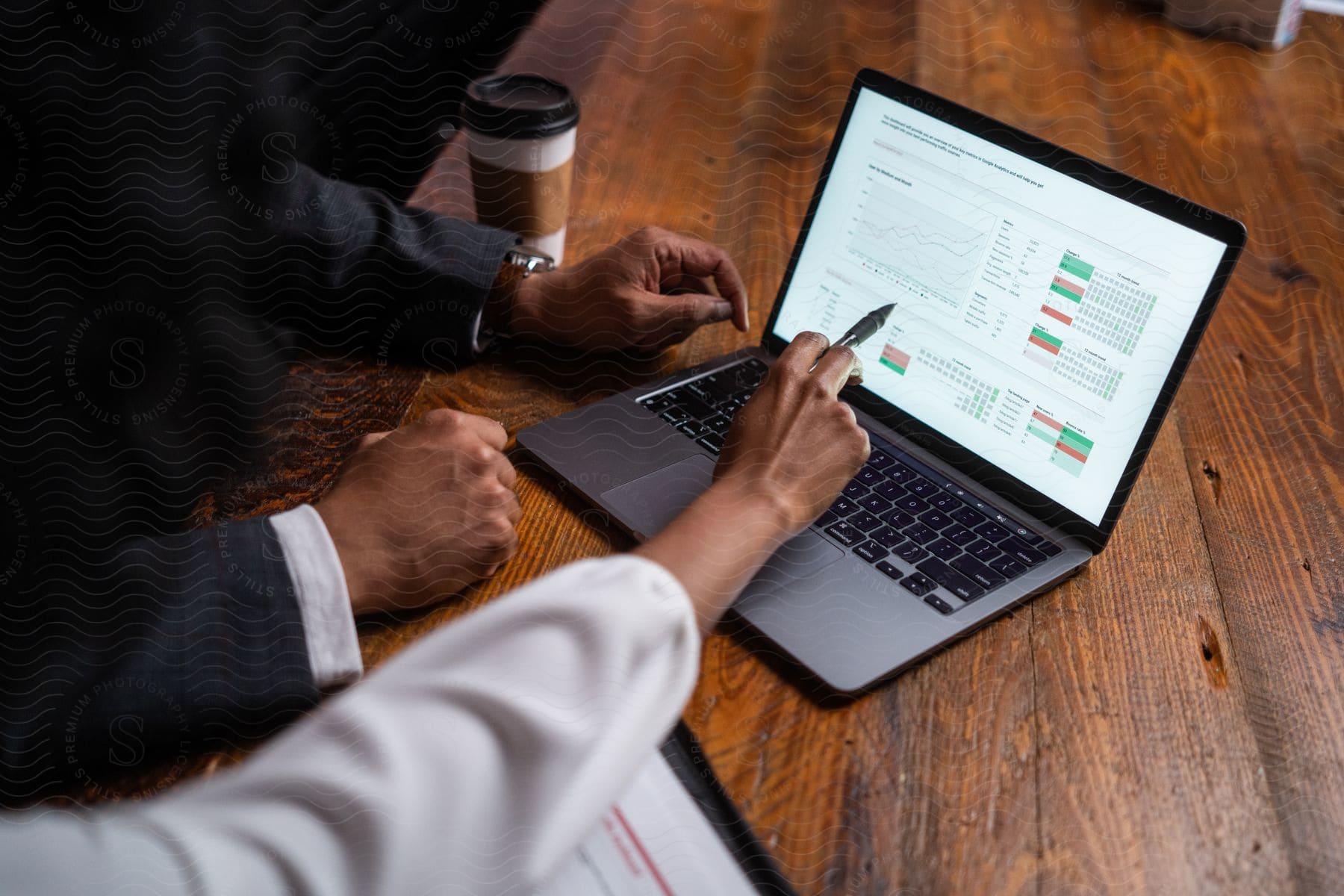 Stock photo of a man and woman looking over charts on a laptop.