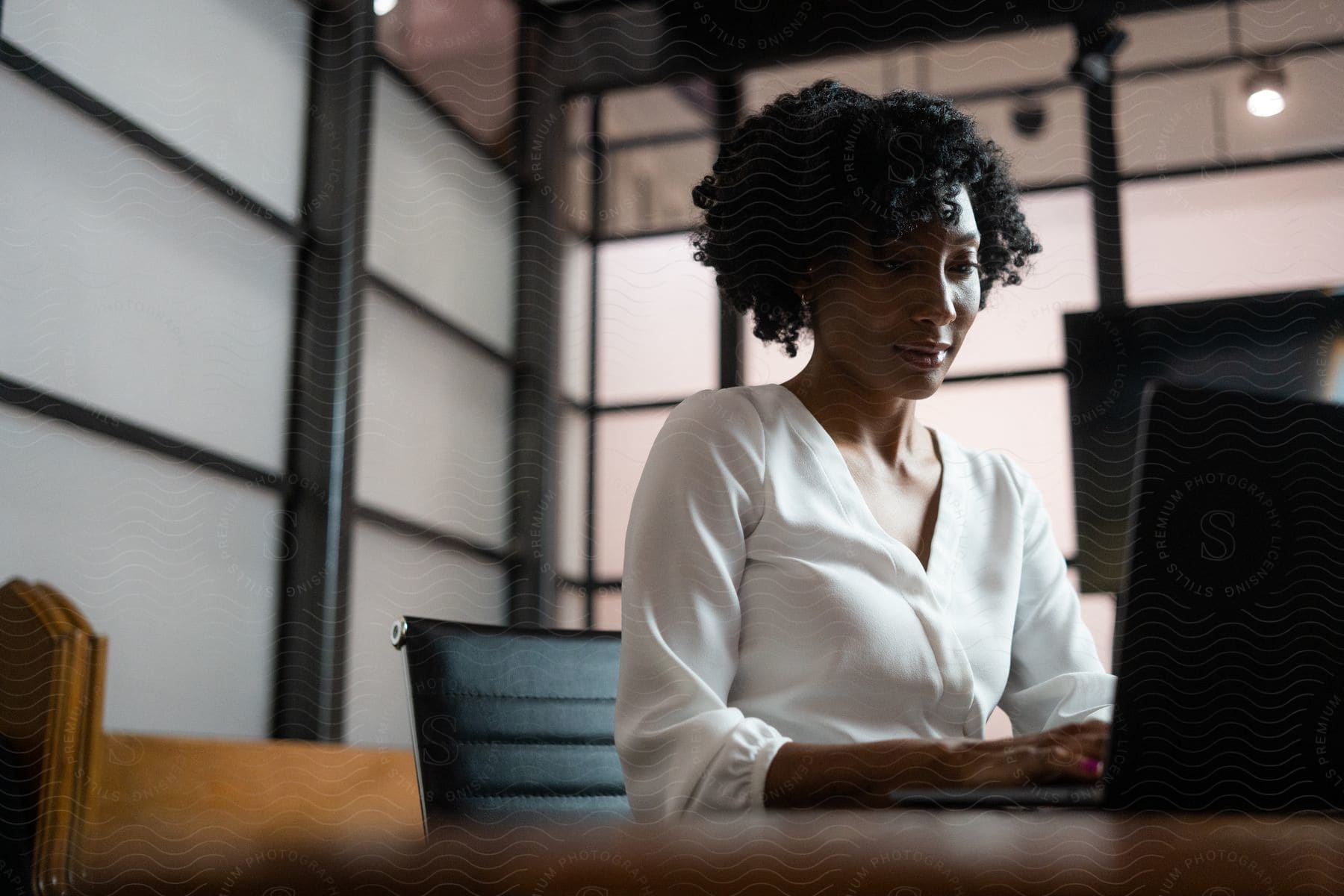 Stock photo of a woman sitting at a desk using her laptop