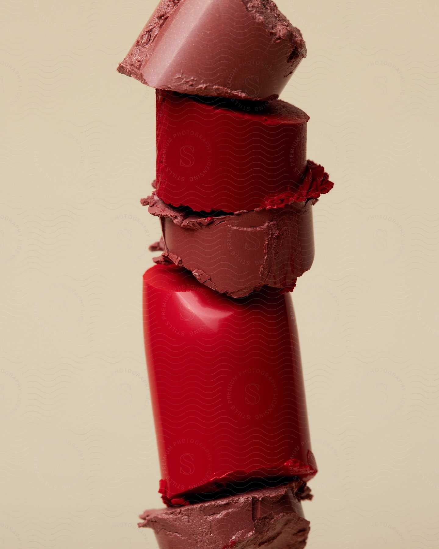 Close-up view of broken lipstick pieces stacked on one another.