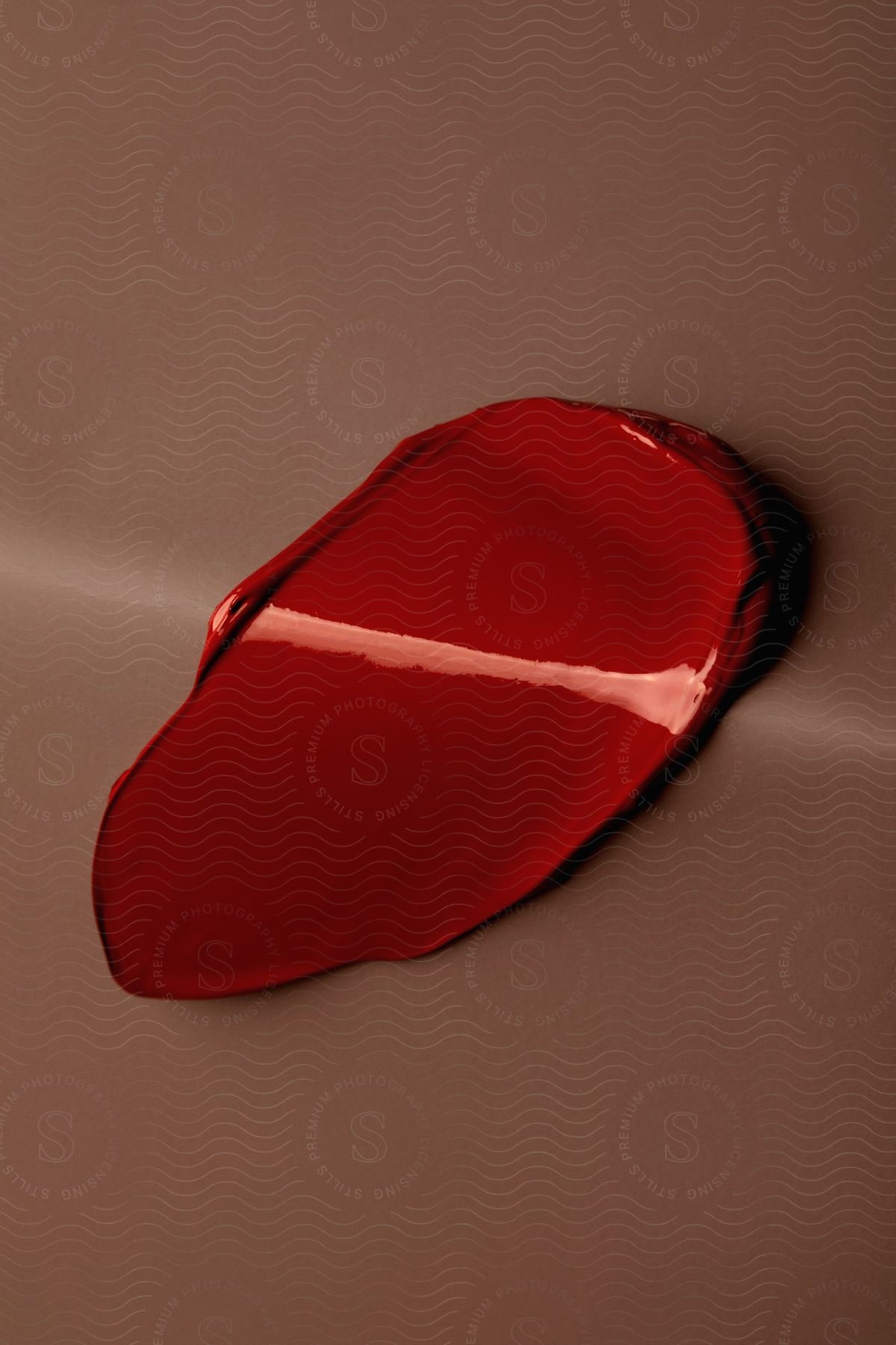 Stock photo of red makeup texture on a surface.