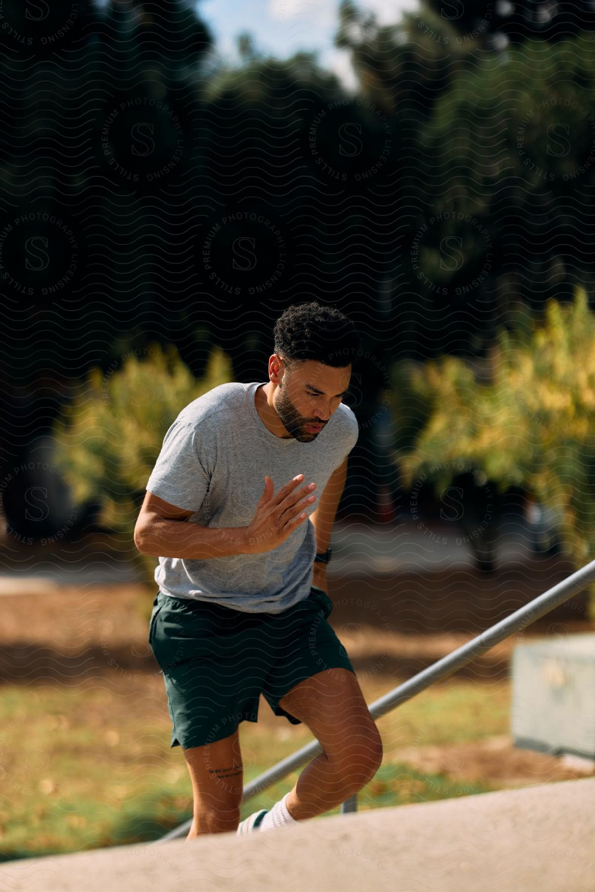 Black American man running on stairs outdoor at mid-day