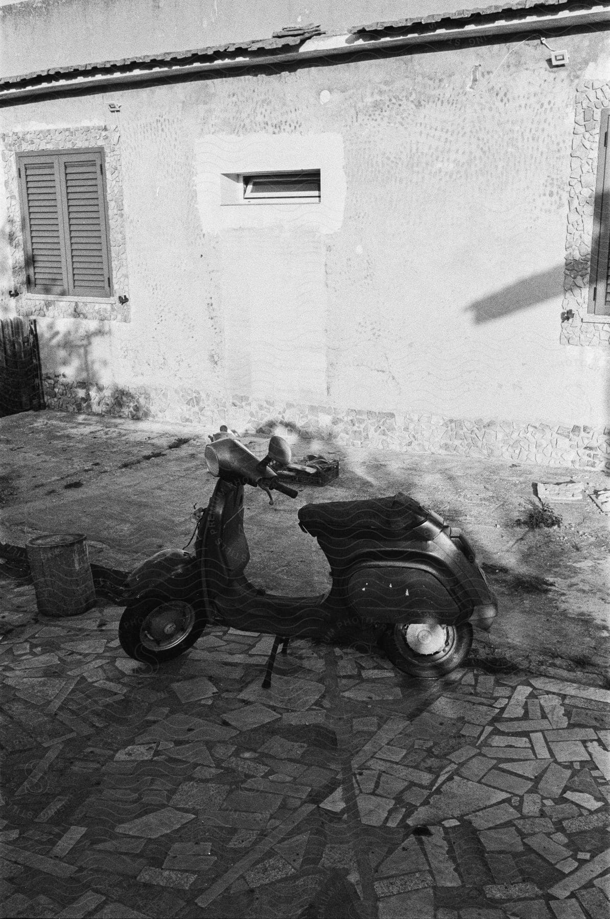 A scooter on a cobbled street.